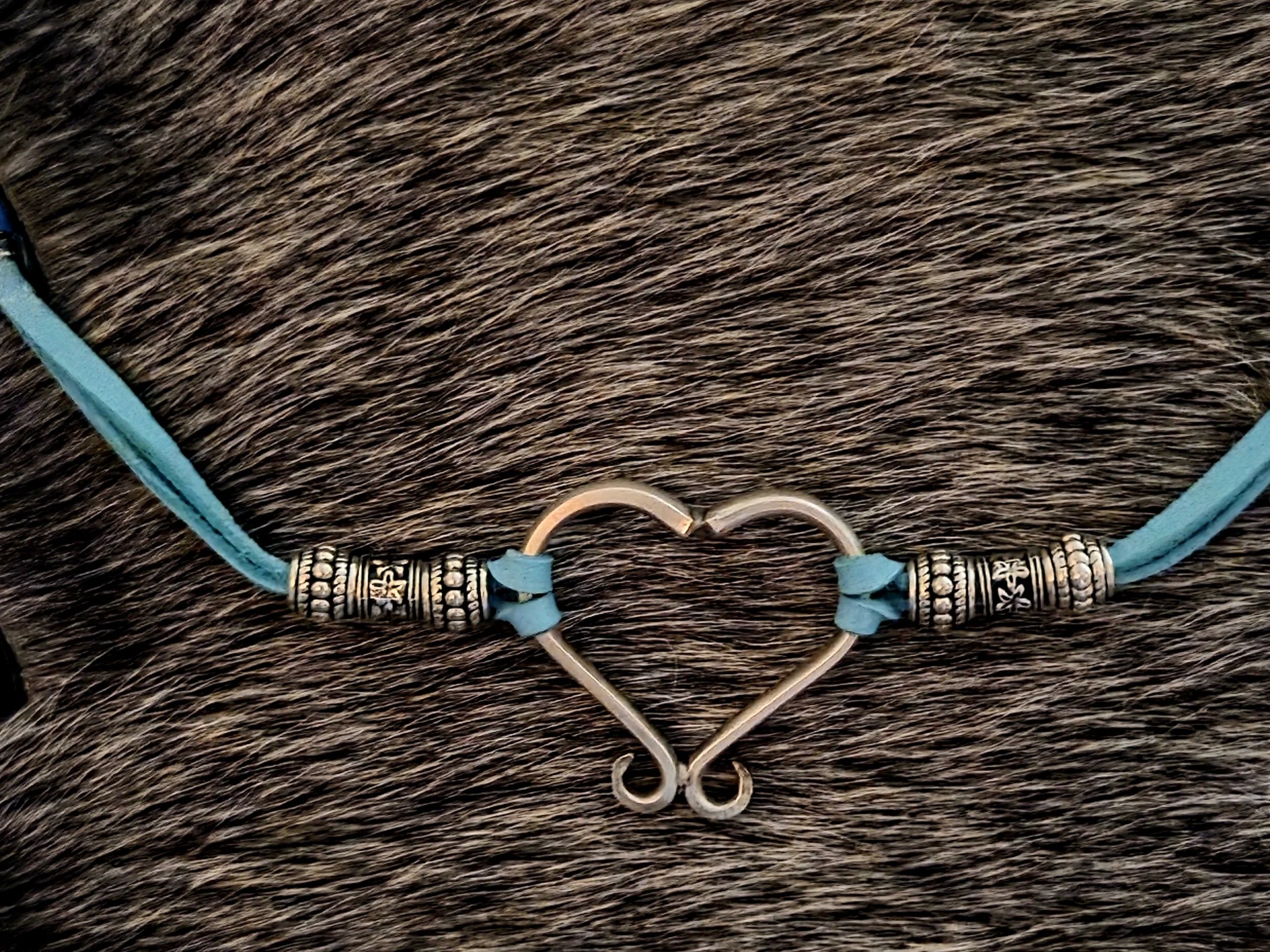 Hill Country Heart Bracelet, handcrafted from two fork tines. This artisan piece pairs repurposed silverware with turquoise leather. Repurposed, upcycled In God We Trust fun!
