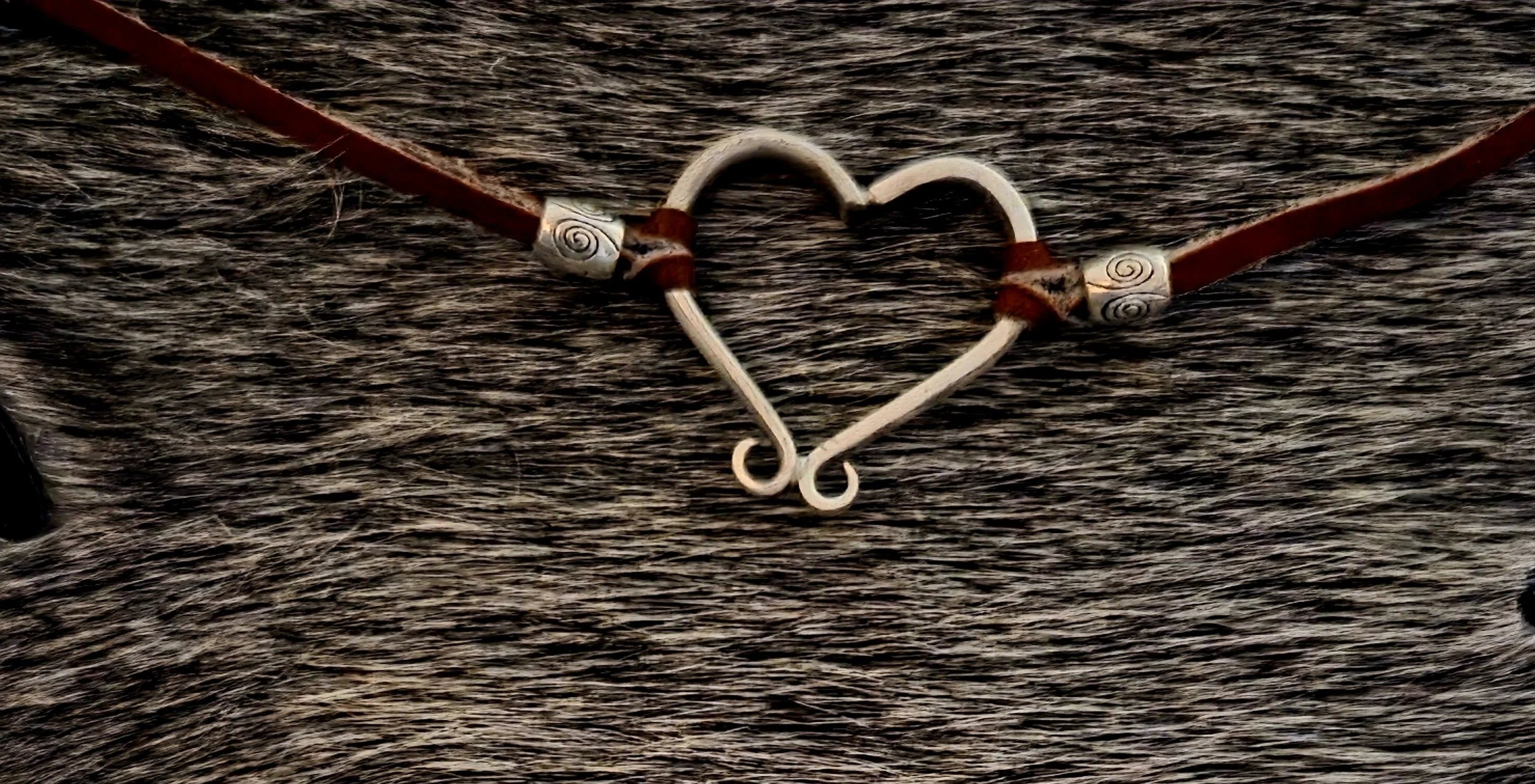 This Hill Country Heart Bracelet, is handcrafted from two fork tines bent to form a sweet heart shape. For this version, we pair repurposed silverware with the saddle brown leather.