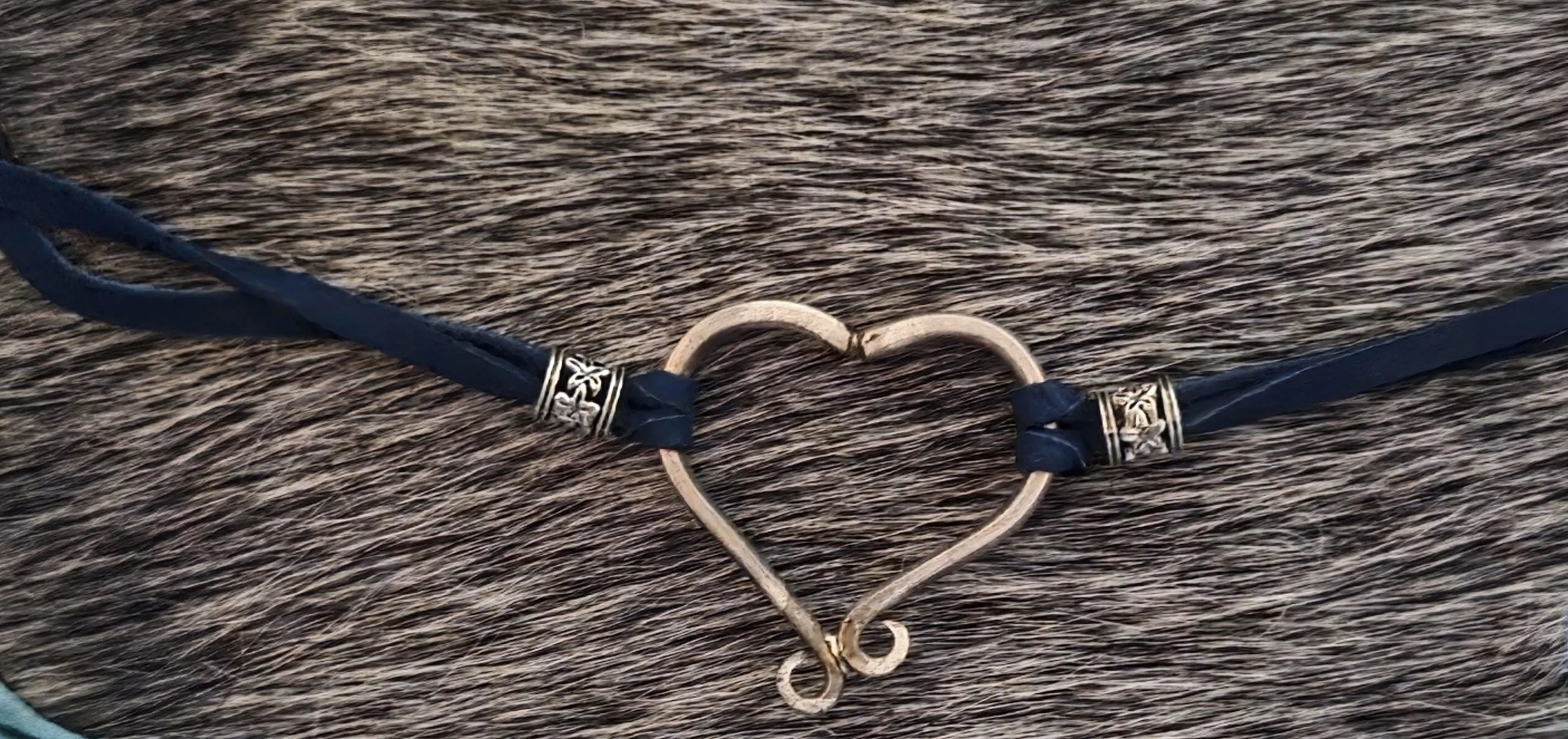 This Hill Country Heart Bracelet, is handcrafted from two fork tines bent to form a sweet heart shape. For this version, we pair repurposed silverware with navy leather.