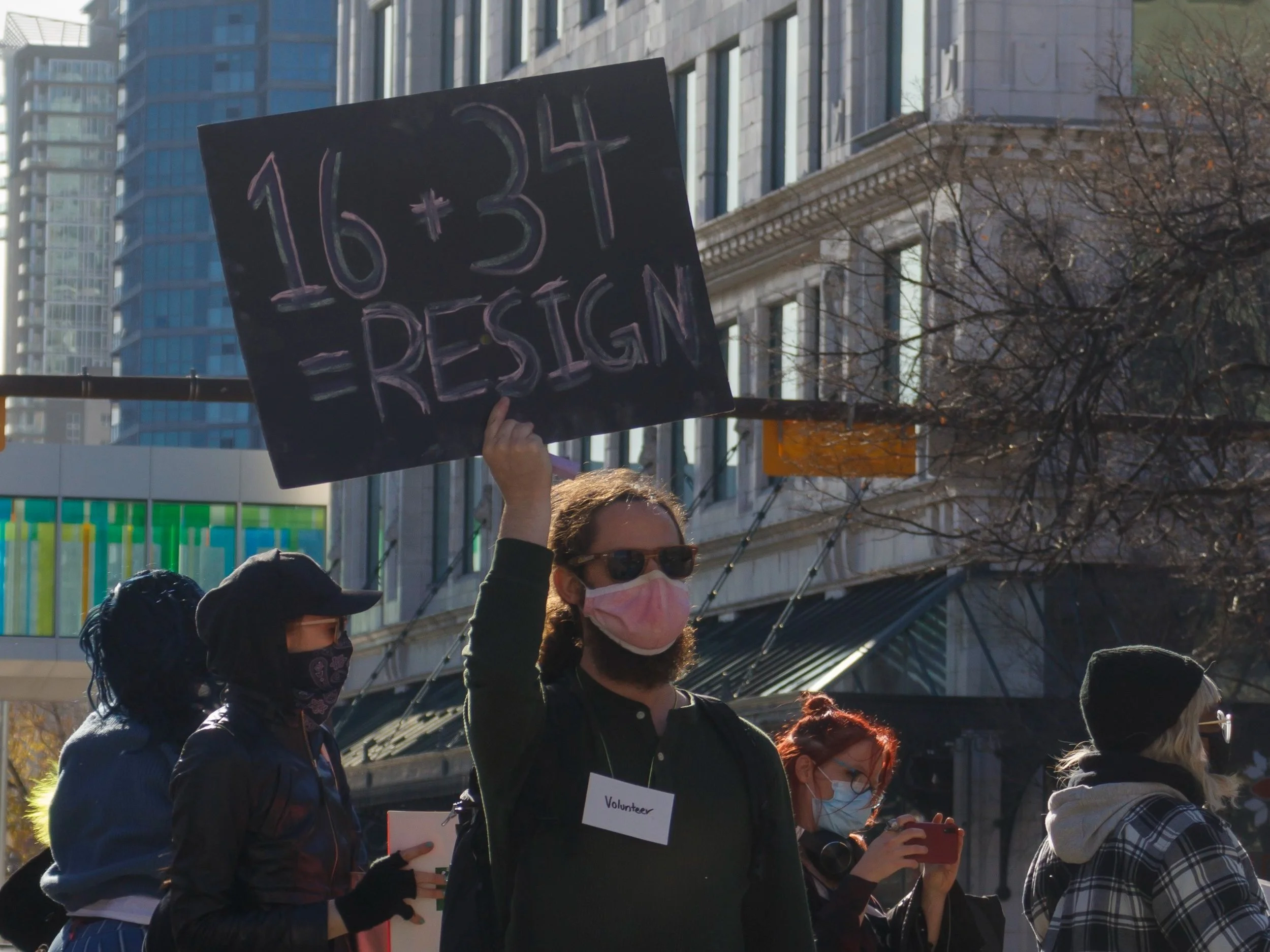 A protestor holds up a sign explaining why City Council member Sean Chu of Ward 4 should resign in front of City Hall on MacLeod Trail North. Downtown Calgary, AB, Canada 17/10/2021