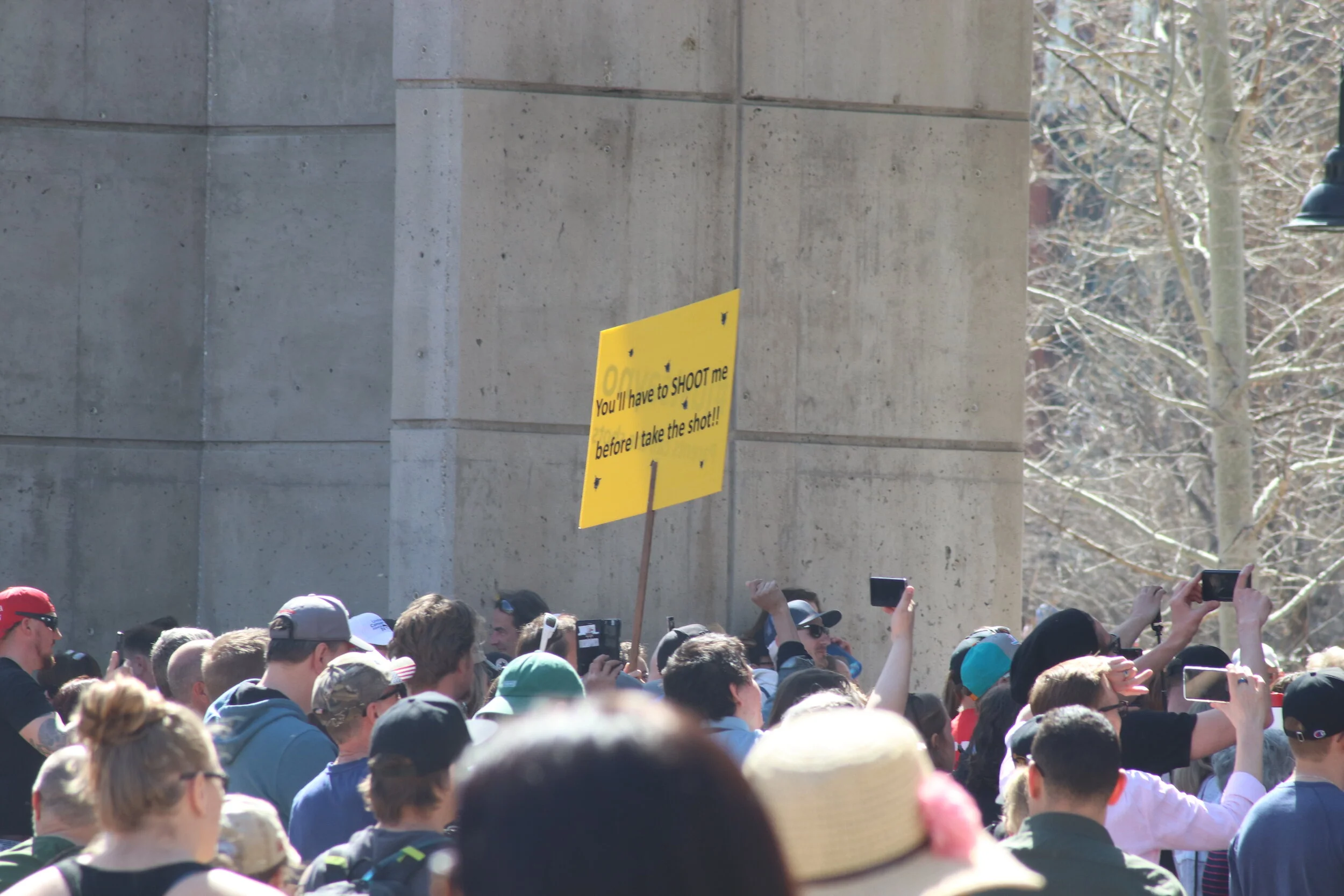 Protester holding a powerful sign at the Walk For Freedom Rally at Princes Island Park in Calgary AB on 17/04/2021