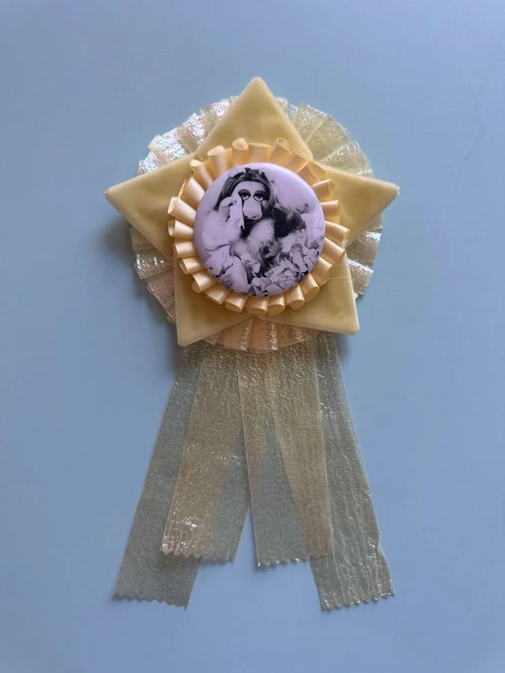  Handmade prize ribbon with a graphic of miss piggy surrounded by pleats and a star 