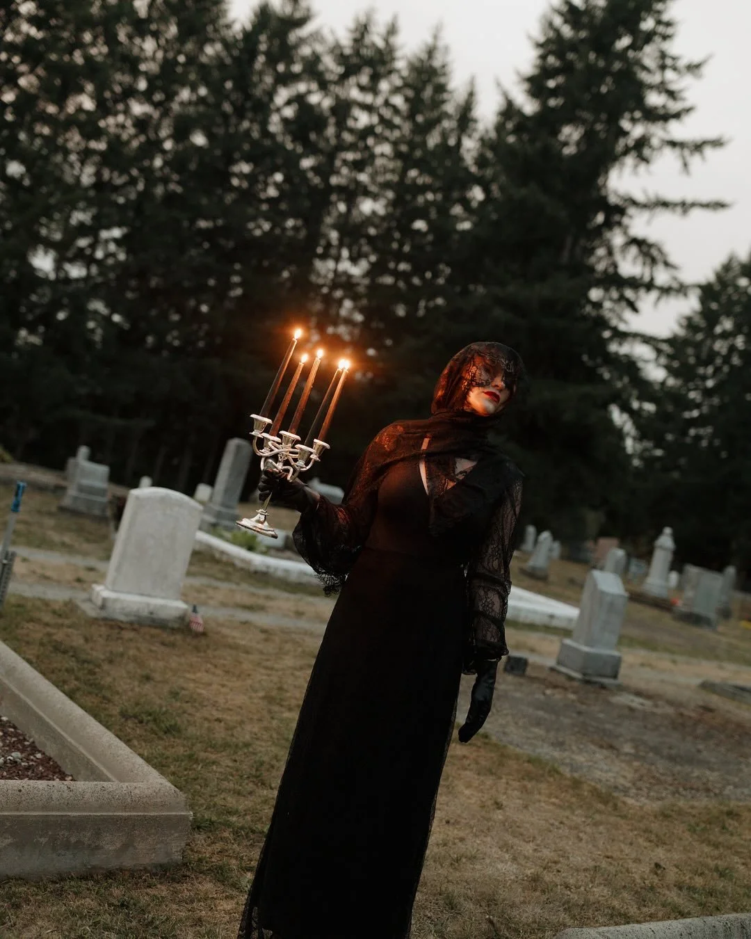 She came only at night, cloaked in black, drifting through the iron gates as if the earth itself released her. At each grave she stopped, bowing her veiled face, her hands trembling against stone. No words left her lips, only a low sound&mdash;half s