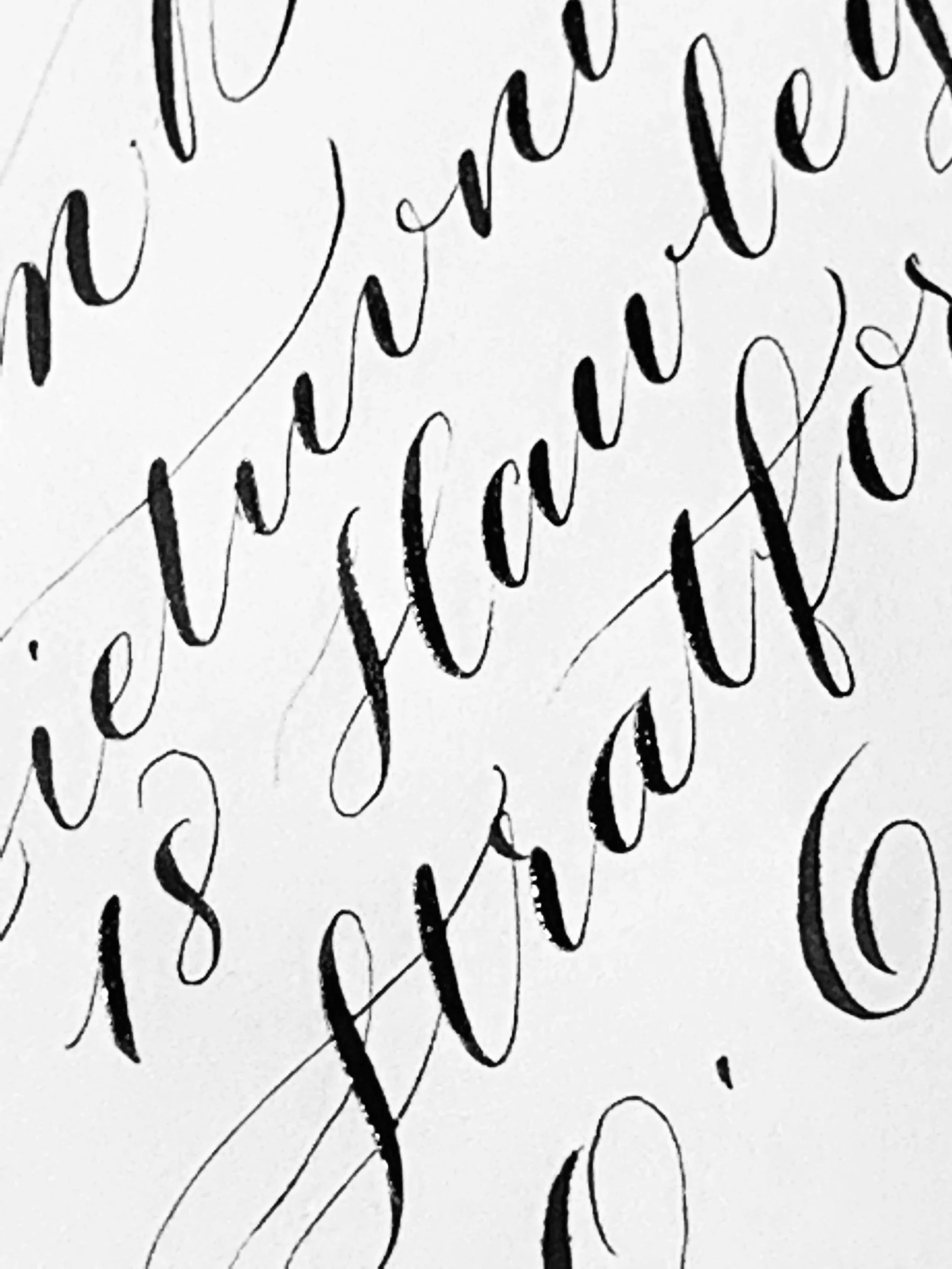 Close-up of cursive handwritten text in black ink on white paper.