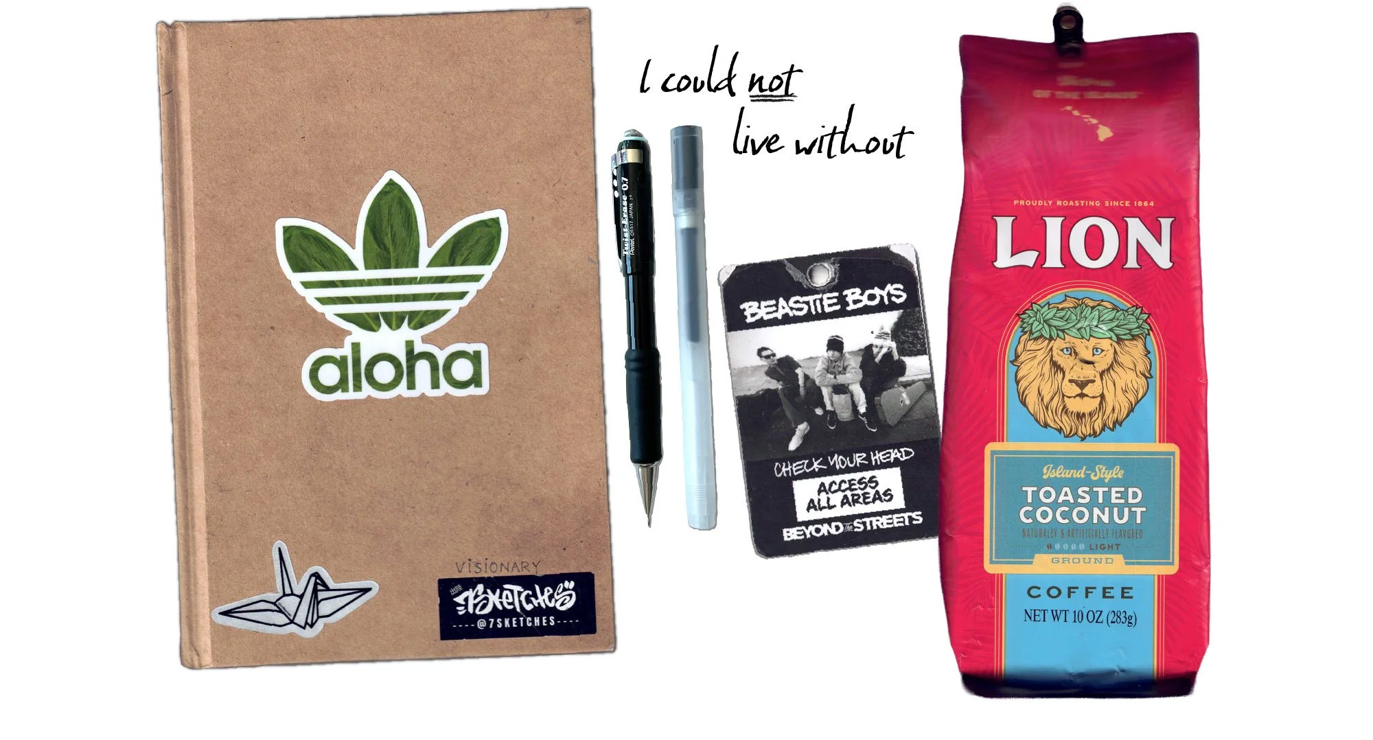 A flat lay of various items including a brown notebook, pens, a card with the beastie boys and a photo of Lion's Hawaiian coffee