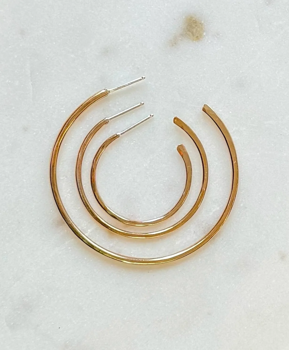 Tis the season for jewelry posts. Naked Hoops are back in stock and with an added size. Now available in S-L.
14kt gold fill
Hammered detail
Handcrafted in Richmond, VA
Small approx 1&rdquo; diameter
Medium approx 1.5&rdquo;
Large approx 2.5&rdquo;
A