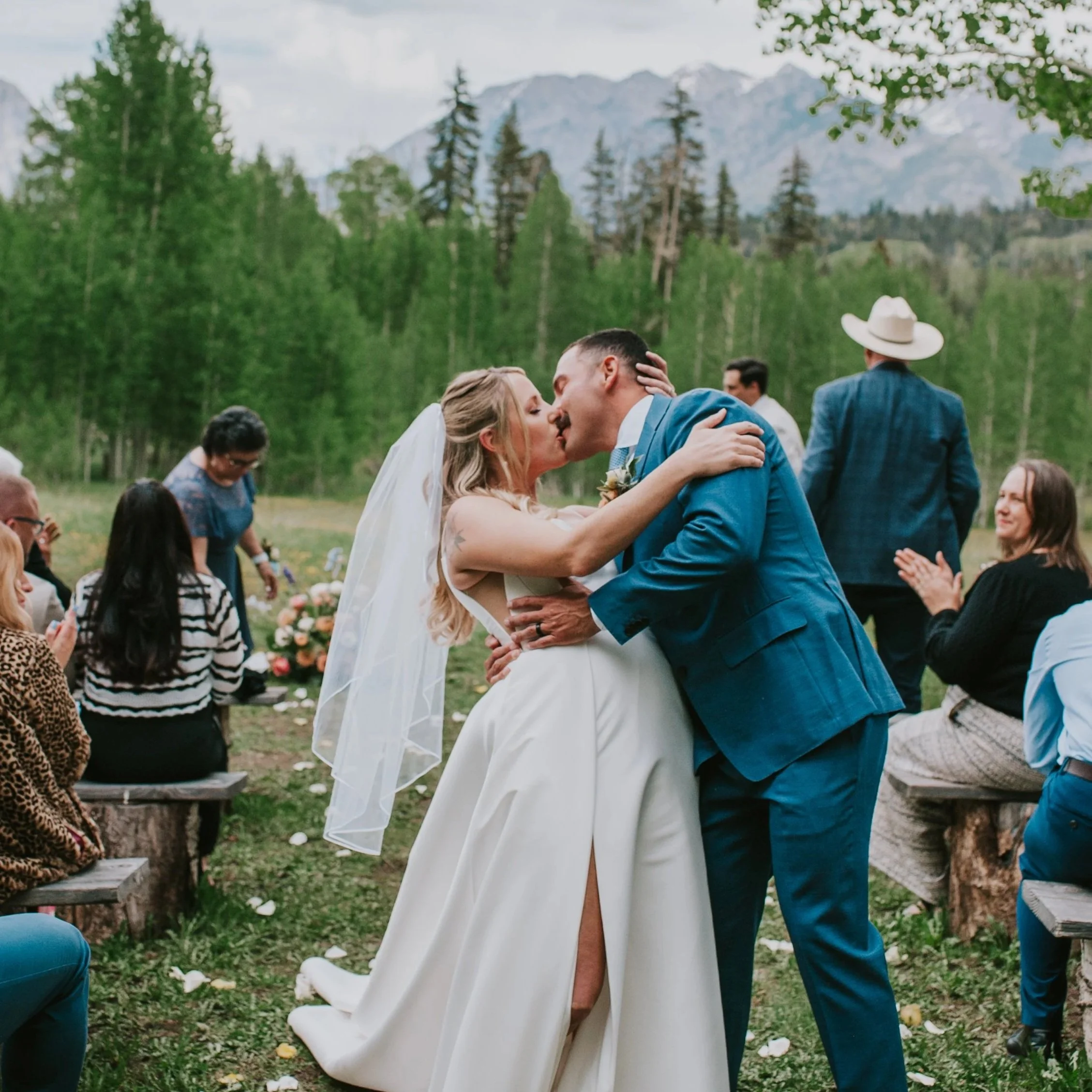 Bride and groom posting for portrait in the Colorado mountains near wedding venue