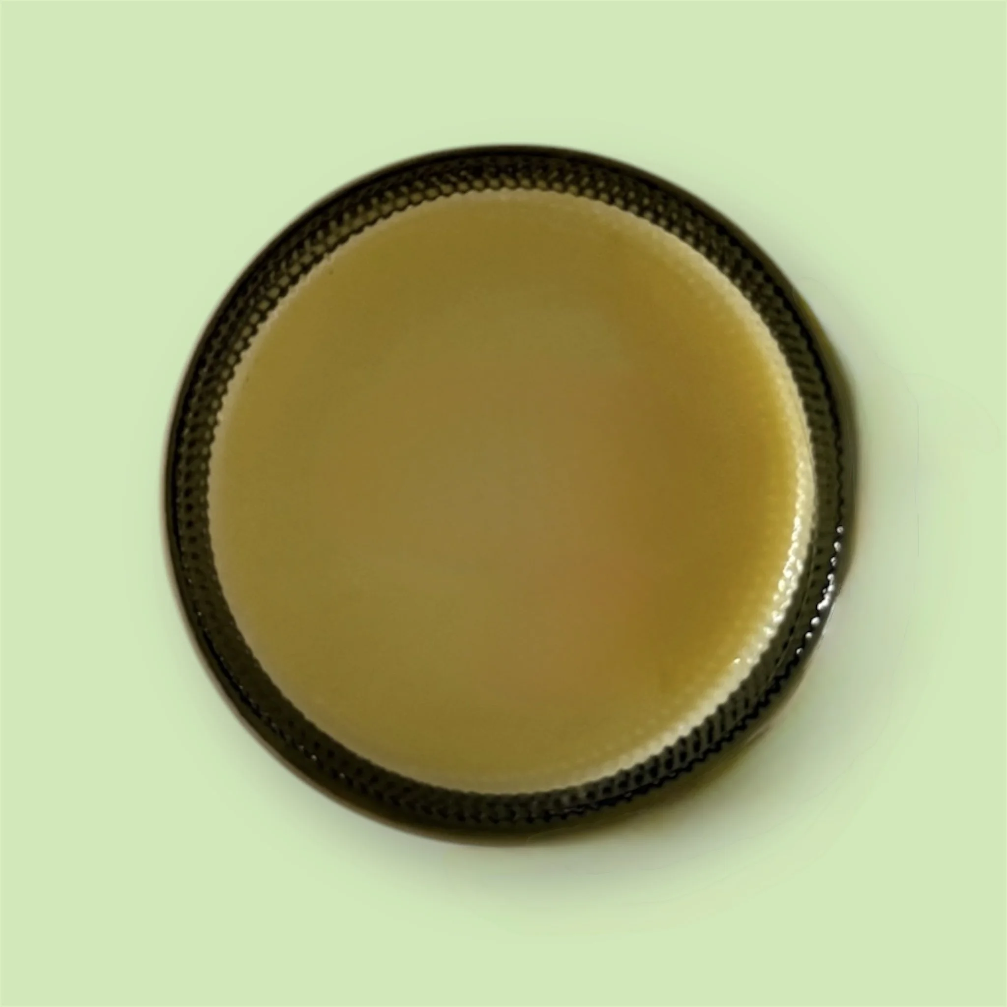 Bottom view of Mint Slice Tallow Body Butter jar, highlighting product details and packaging.