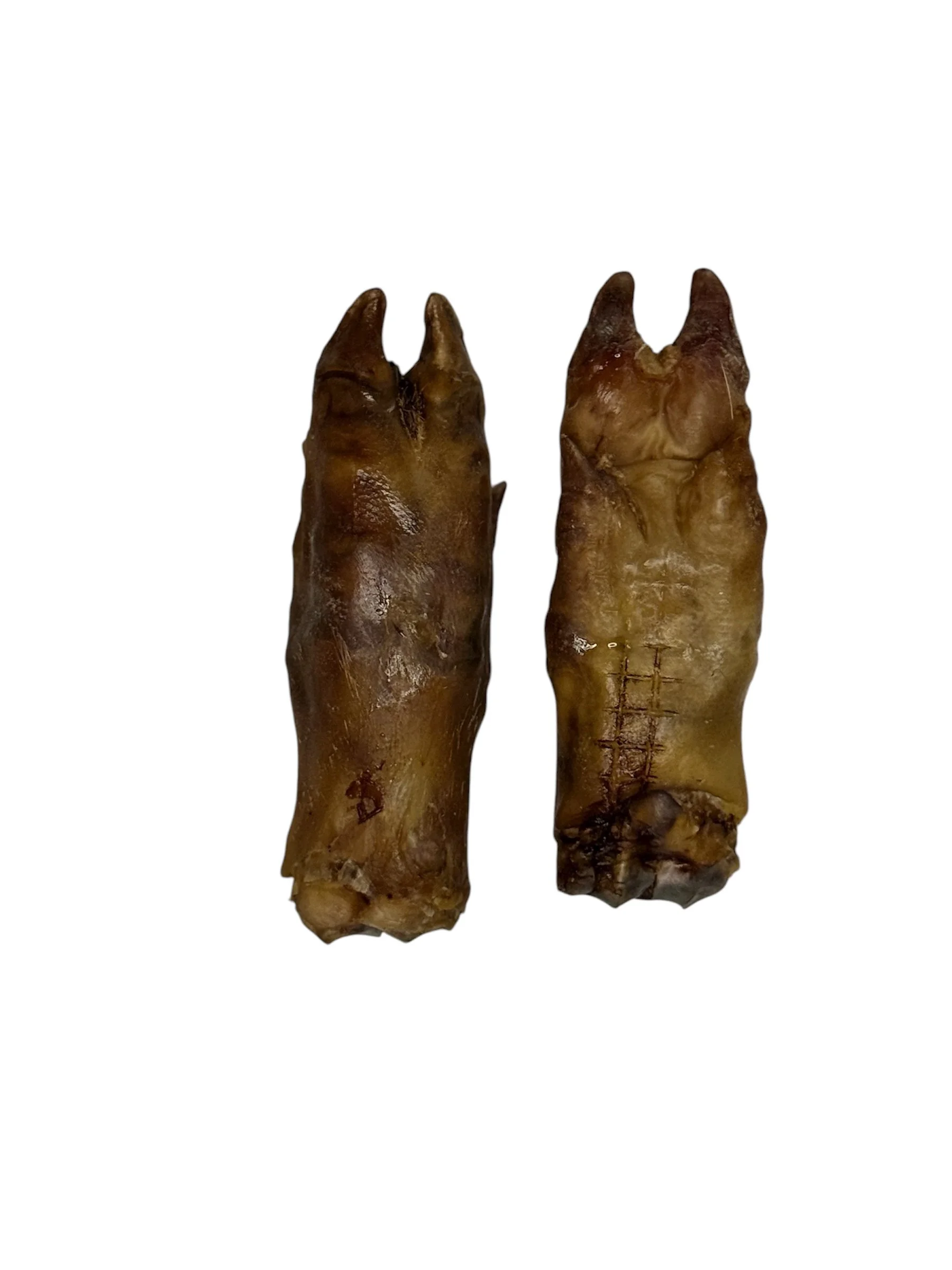 The natural texture and rich colour of the pasture-raised pork trotters are highlighted, showcasing them as a nutritious and wholesome dog treat.