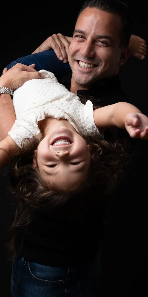 Gezin samen in de studio tijdens een ontspannen fotoshoot met hun kind