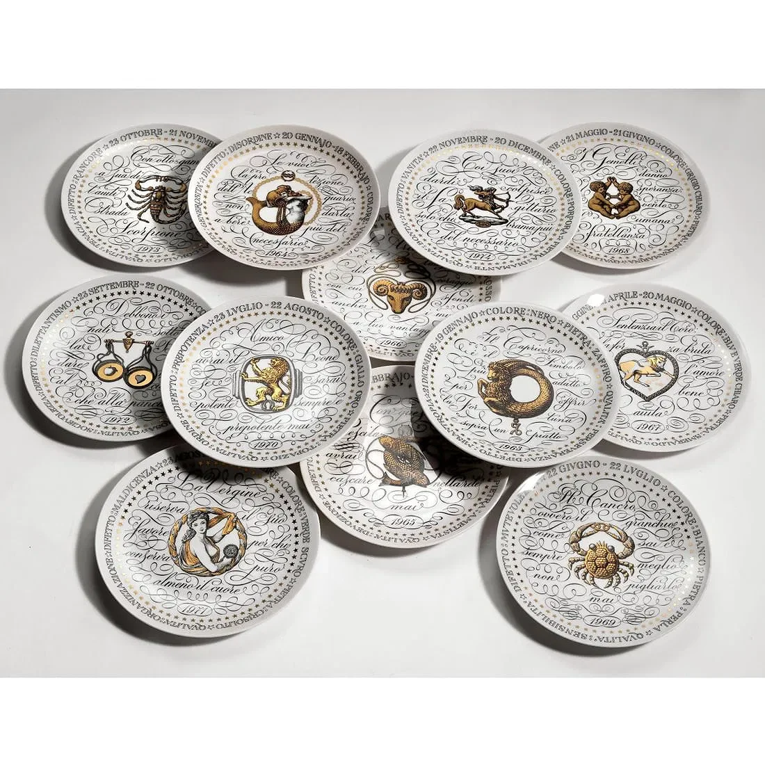1965, 12 Italian plates, Fornasetti