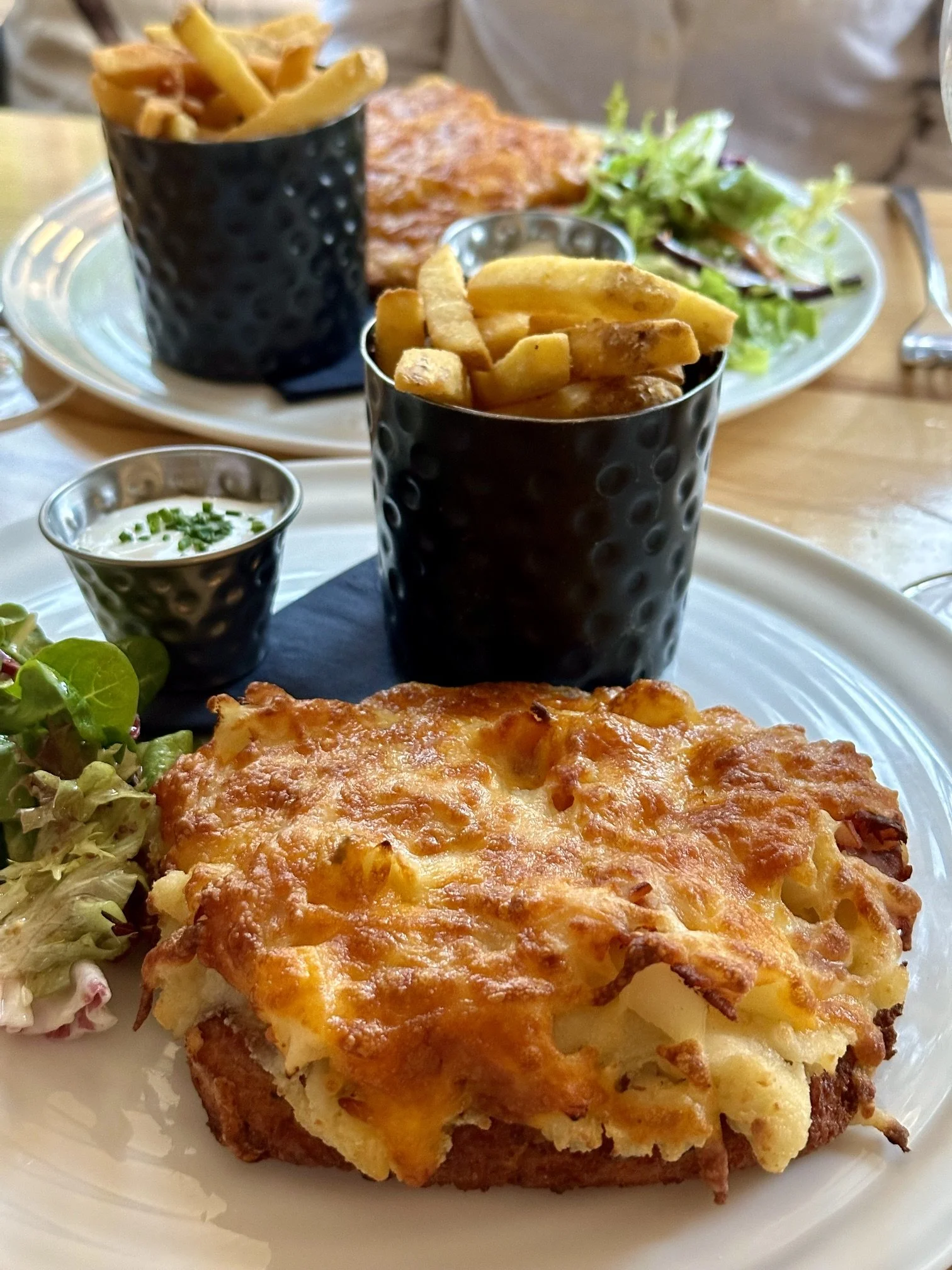 A chicken parmo topped with ham and pinapple, served at The Tiger Inn