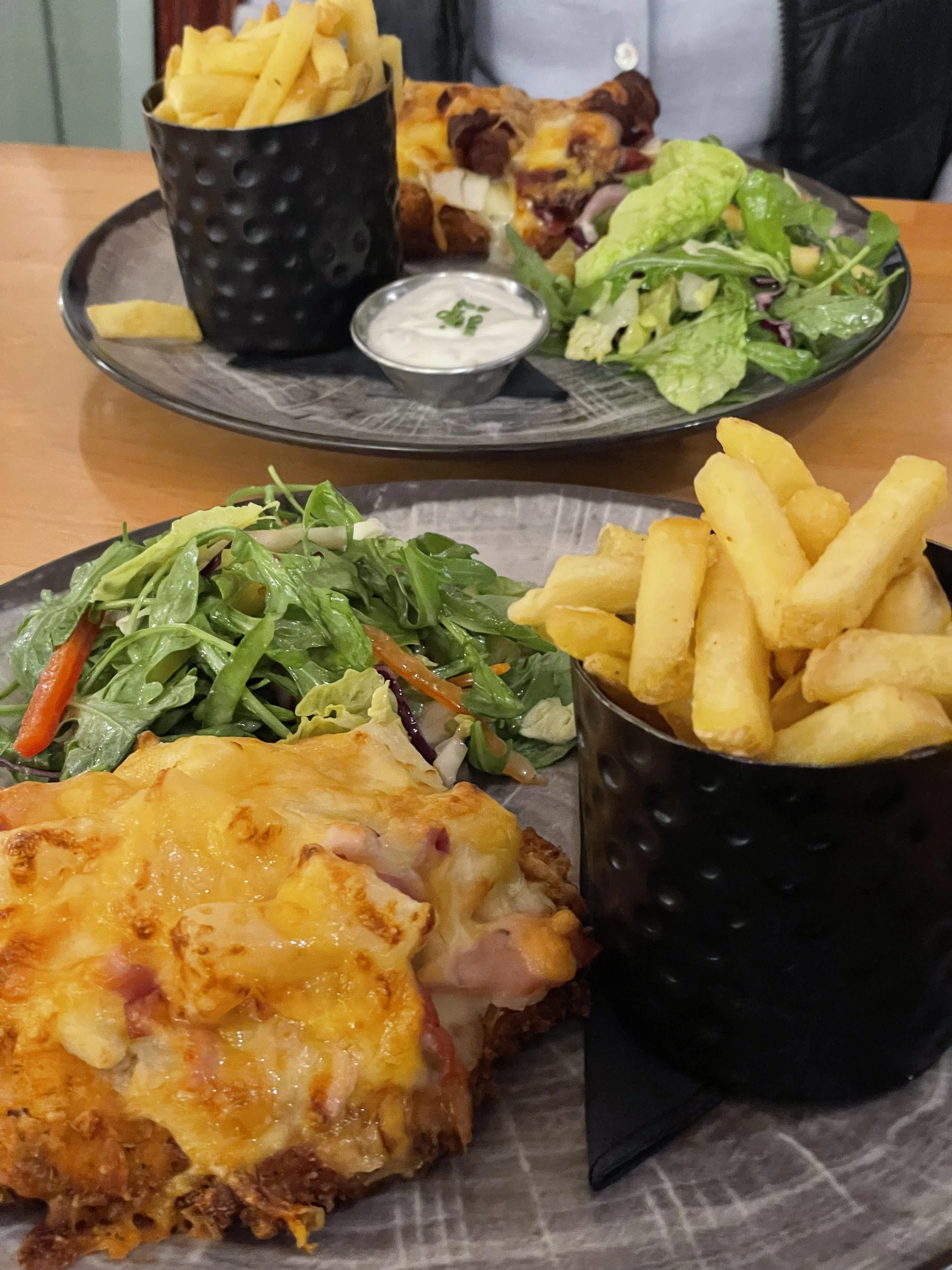 Chicken parmo with salad and fries at The Tiger Inn