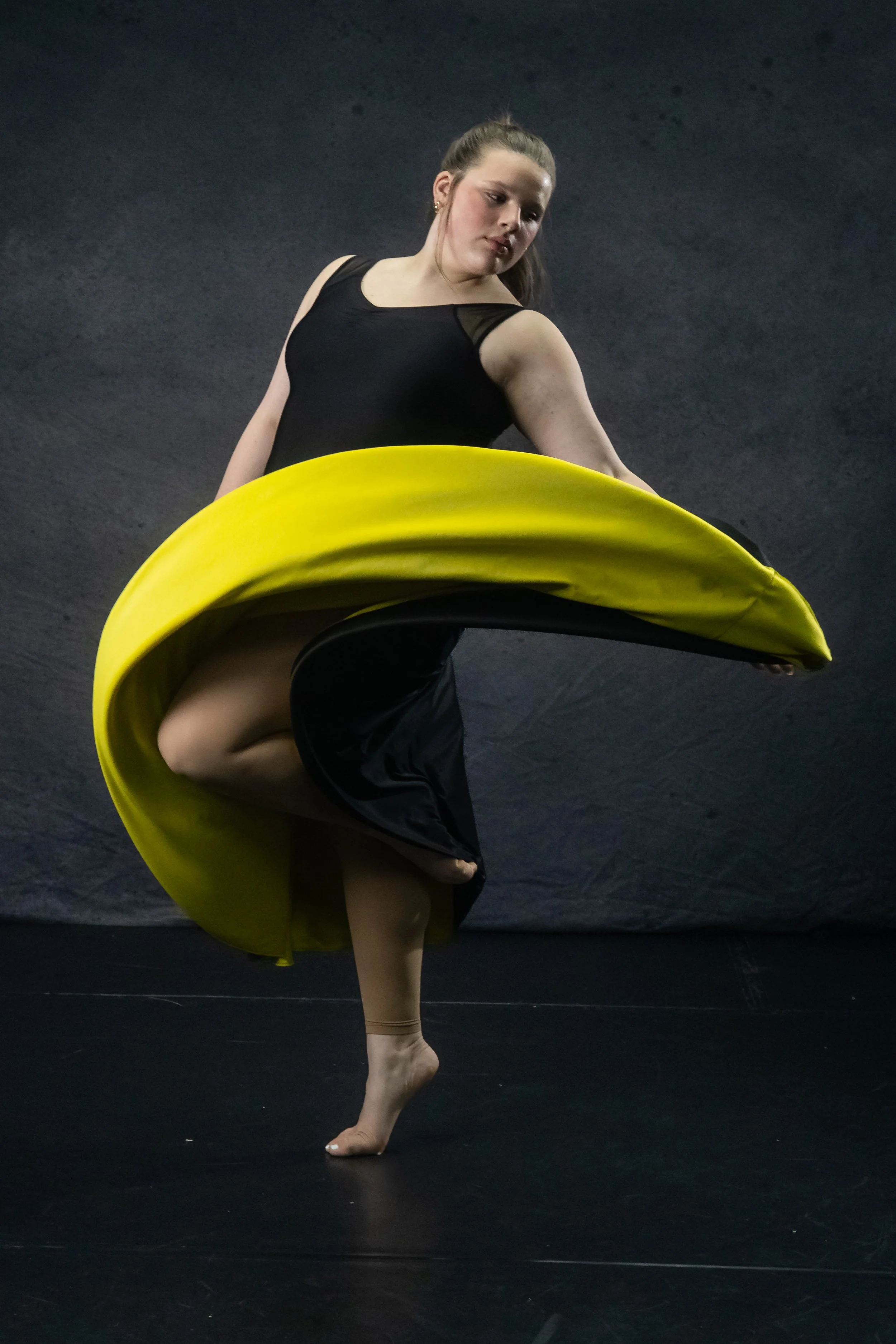 Company dancer throwing her skirt to showcase a pose