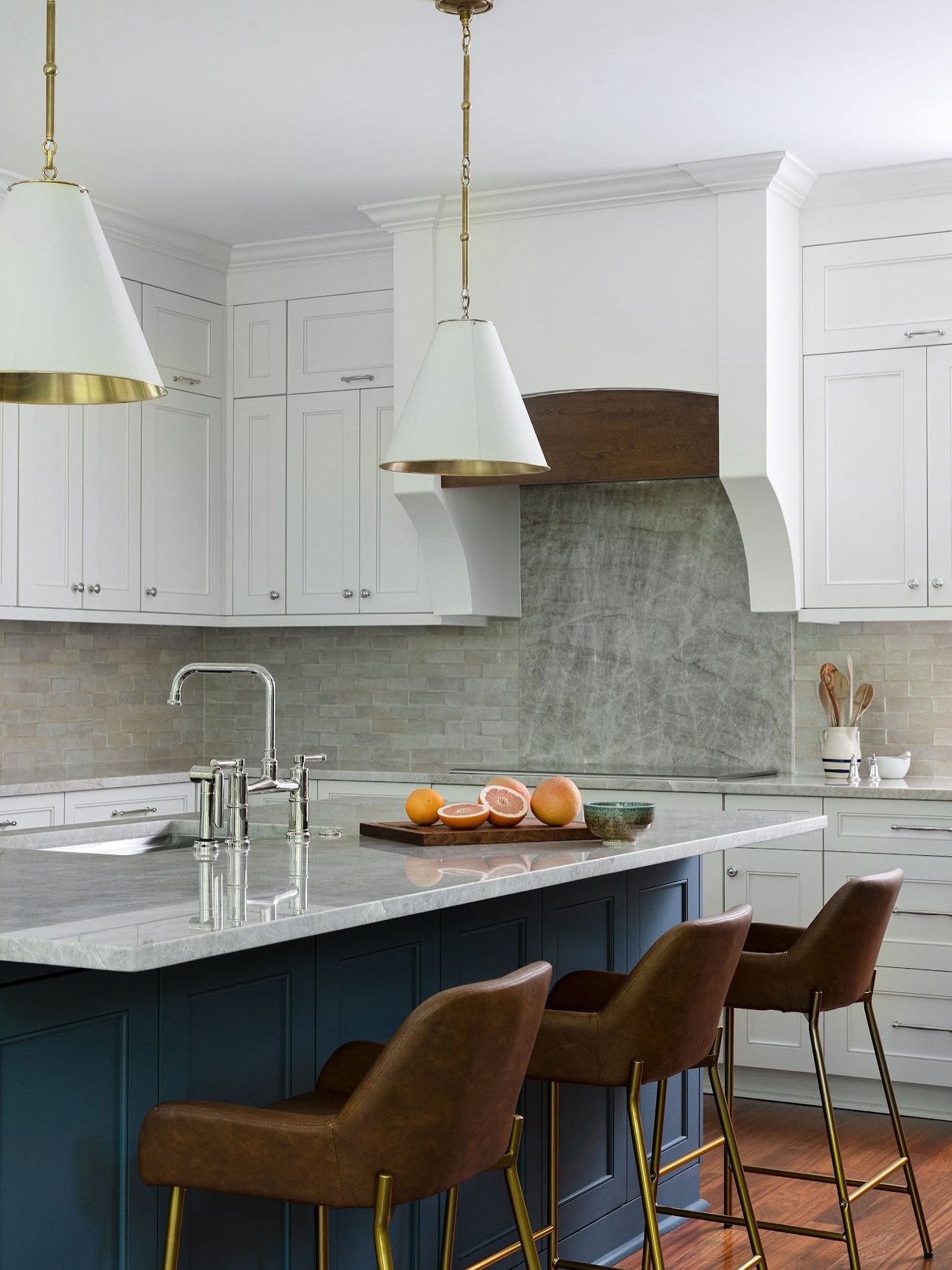 White kitchens aren&rsquo;t boring. We layered this lakefront kitchen with color and texture creating a comfortable and functional space for family gatherings. We updated the floor plan to include more seating, a coffee bar, and an expanded layout ma