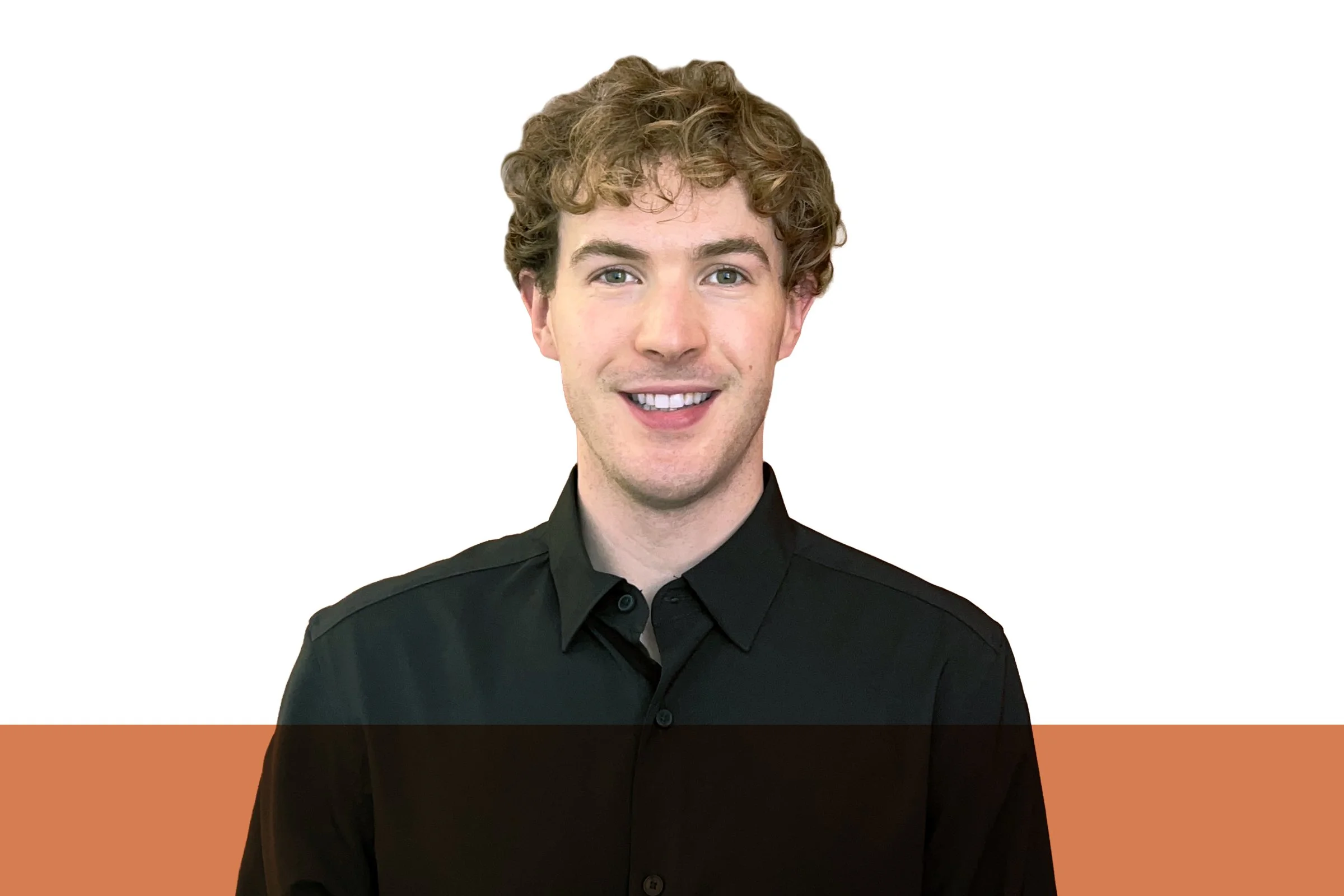 A young man with brown hair smiling, wearing a checkered shirt, standing against a white and orange background.