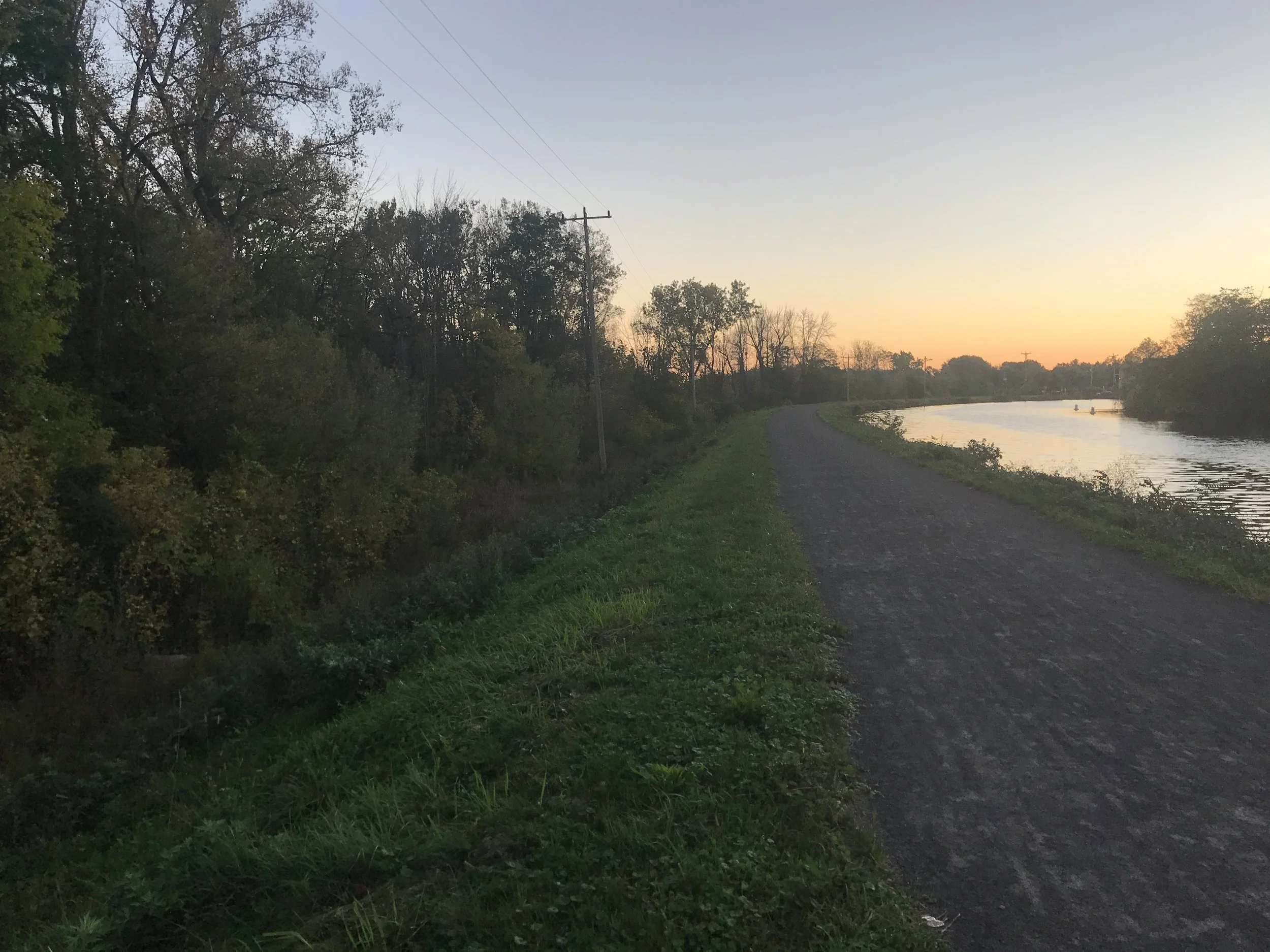 Earthen Embankment, Brockport, NY | An earthen embankment dam where the outboard slope was cleared previously. Unlike dams where the extent of clearing and restoration is extended 15 feet beyond the toe of slope, under the EEIP, clearing of earthen e
