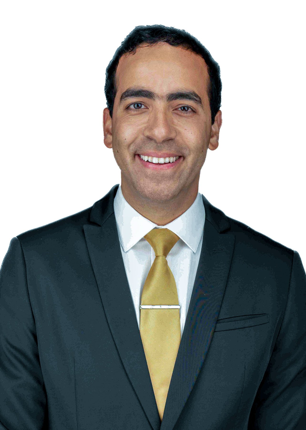 Portrait of a man in a dark suit, white shirt, and yellow tie, smiling against a plain white background.