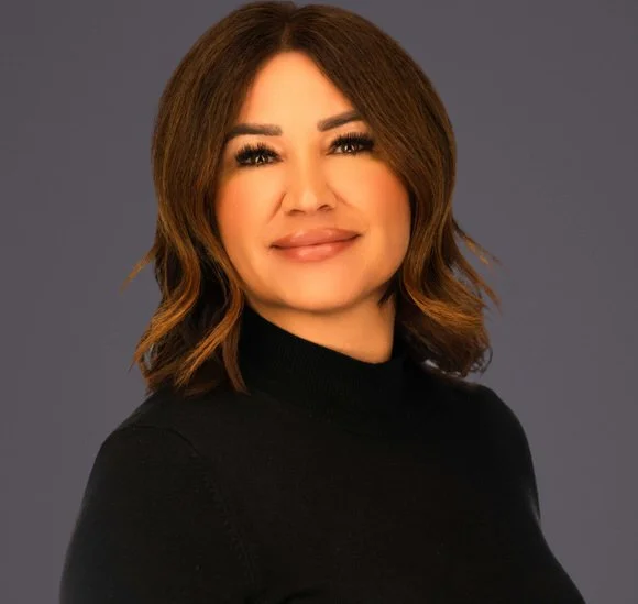 Headshot of a woman with short brown hair wearing a black turtleneck.