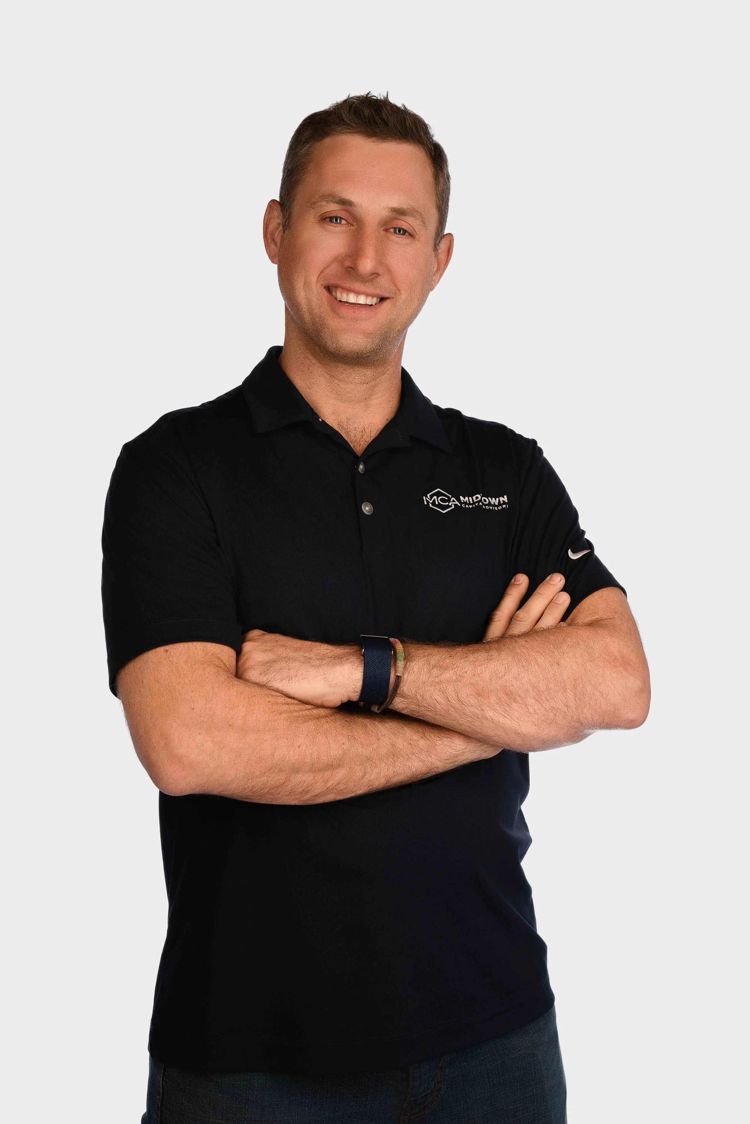 Branding headshot of a business man smiling with his arms crossed