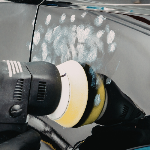 “Swirl marks and light marring visible on car paint under LED inspection light”