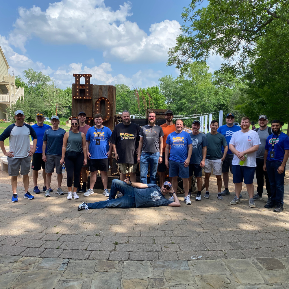 Corporate teams smile after competing in an Amazing Race style event during a Flok corporate retreat