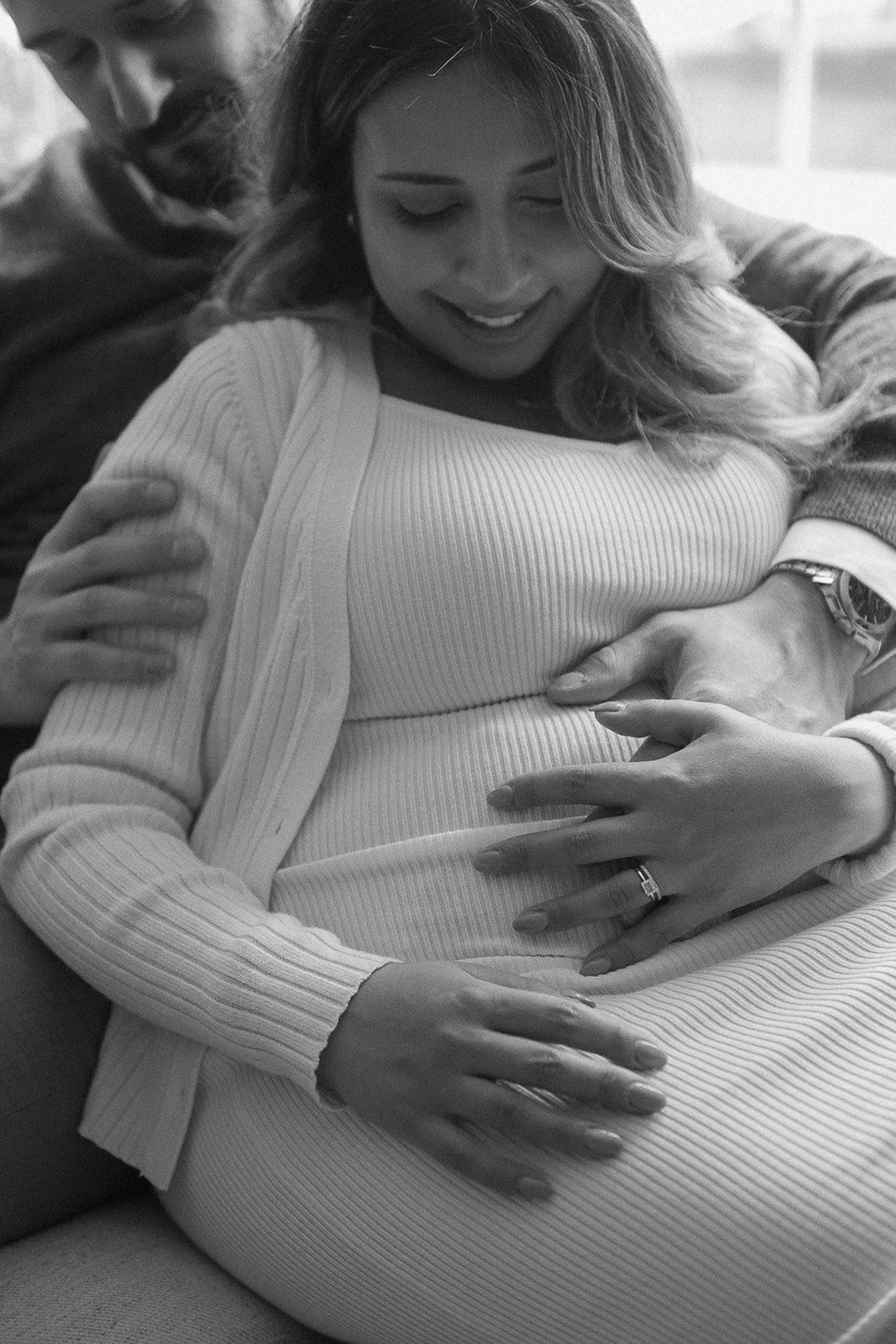 Pregnant wife lying against her husband.