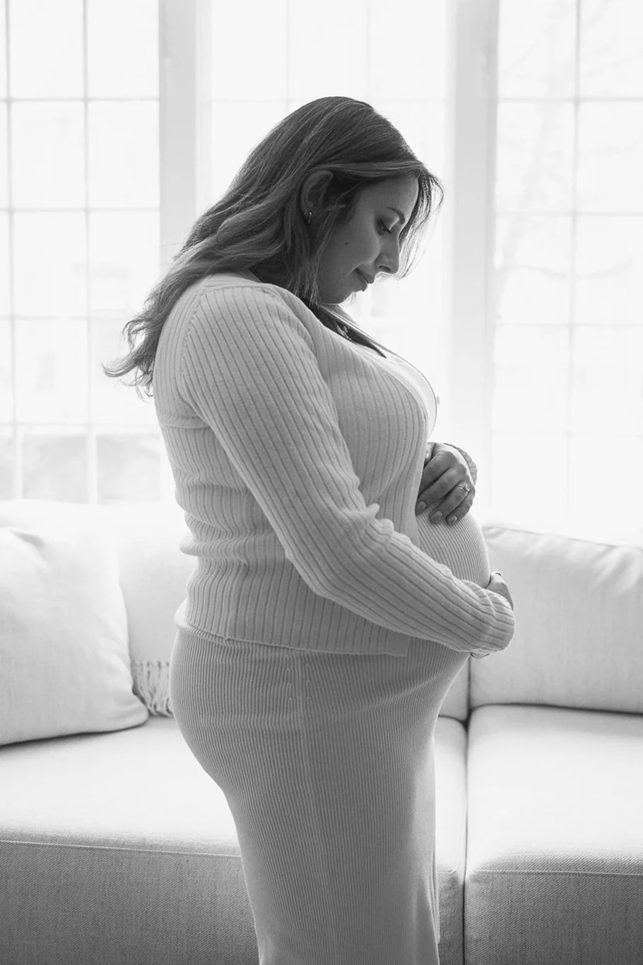 Pregnant woman holding her baby bump.