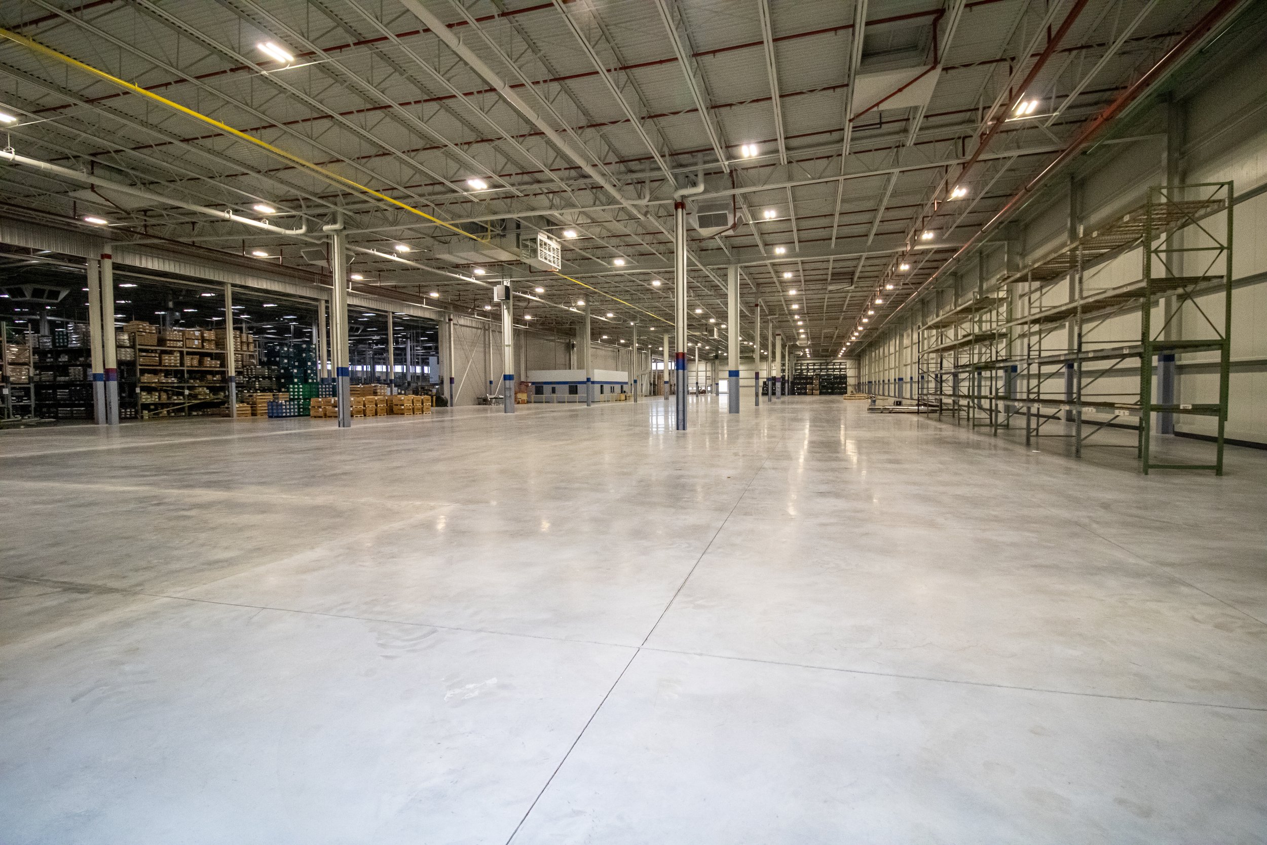 LED lighting installation with nLight controls in expanded industrial facility.