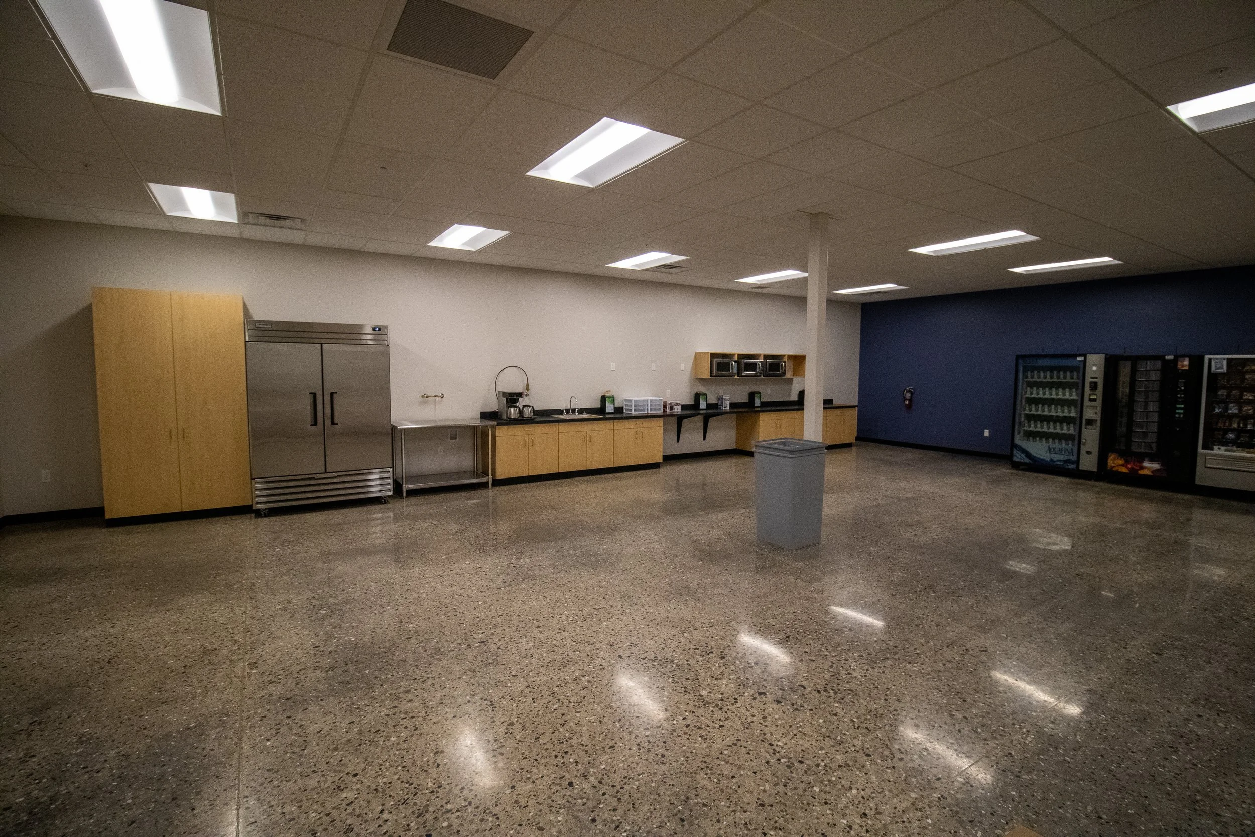 LED lighting installation with nLight controls in expanded industrial facility.