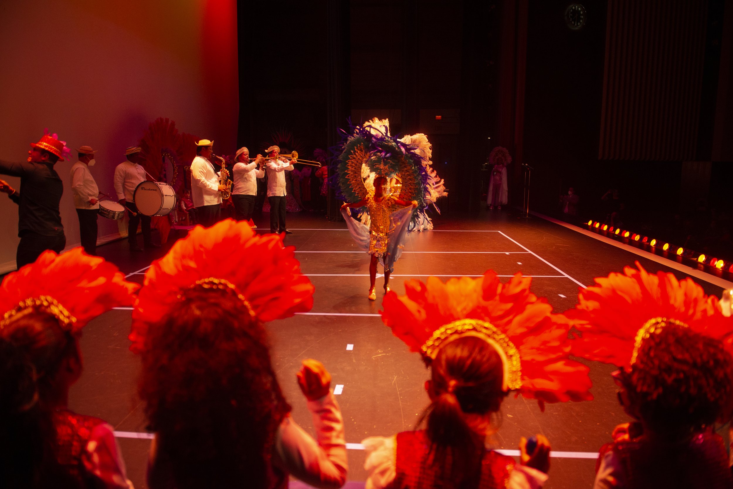 Children in the Cuban dance ensemble cheer on Elanor, who dances in an elaborate, moving set of feathered wings.