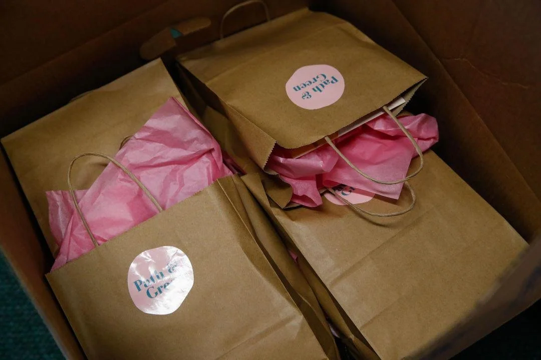 Path and Green Personal Care Bag Program bags laid together in a box