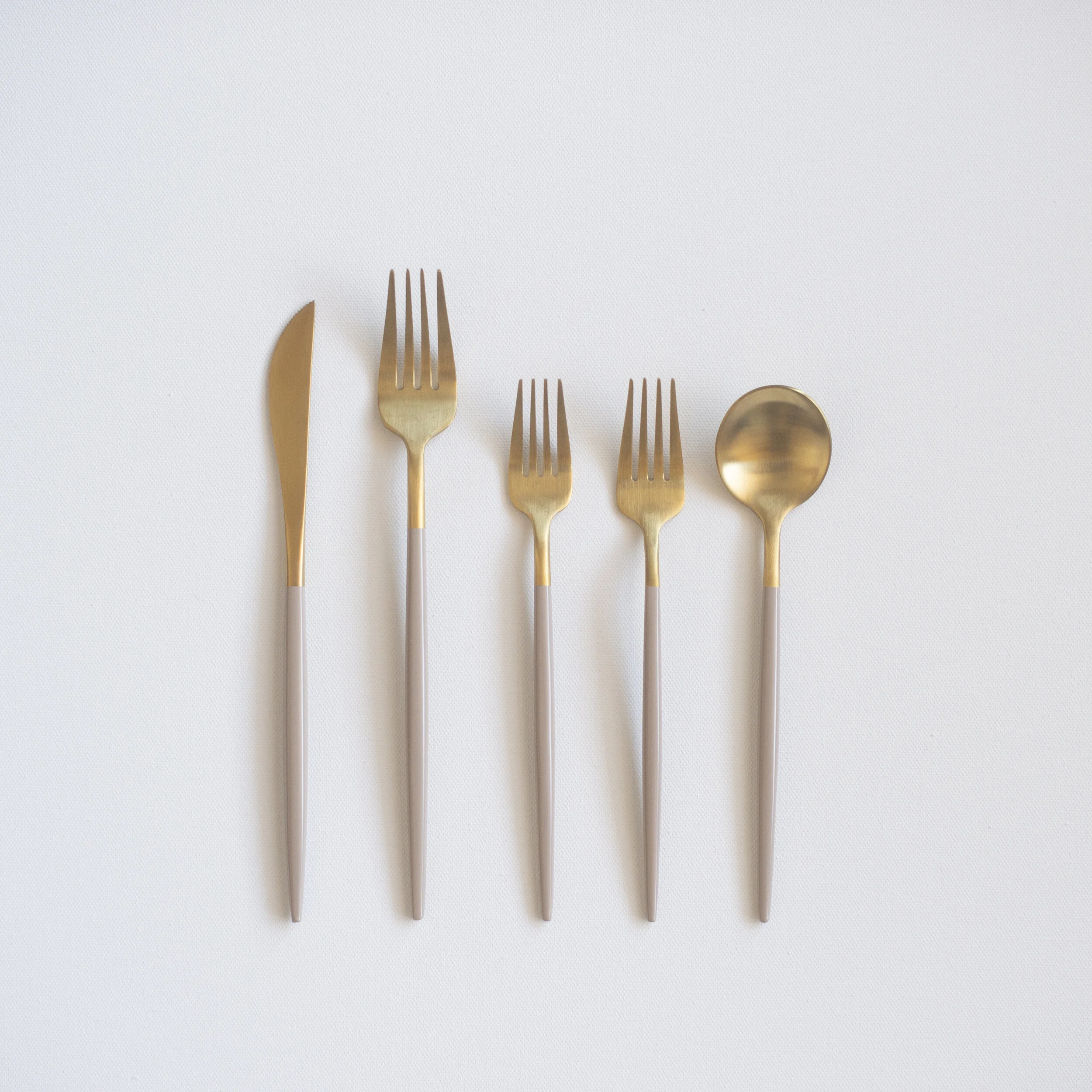 gold flatware rental with beige dipped handles