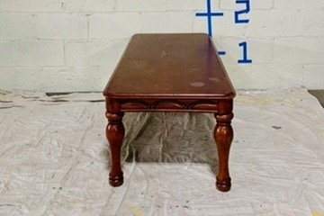 end view cherry wood coffee table against white wall with dimensions