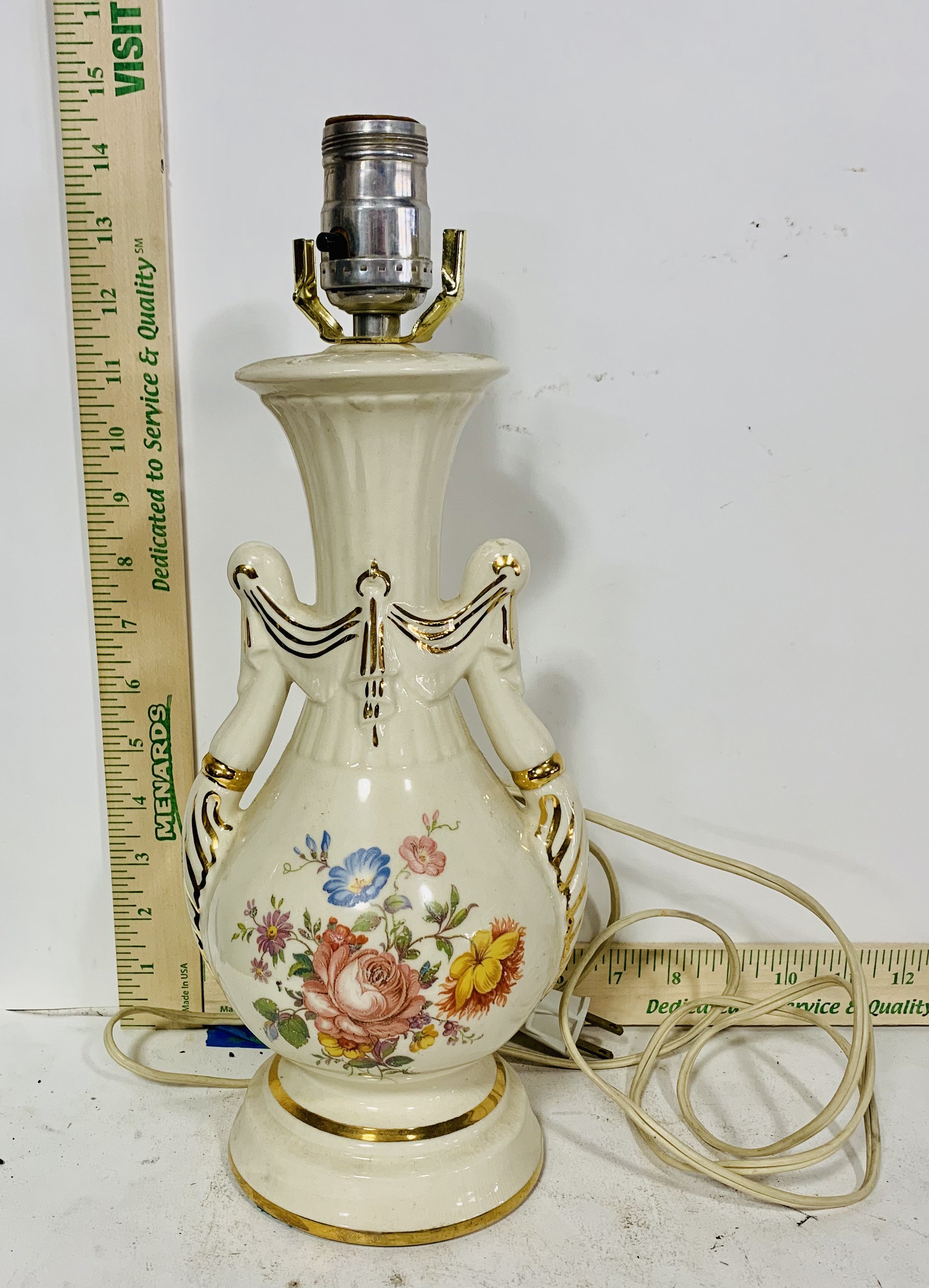 White table lamp with gold detail and floral motif and no shade