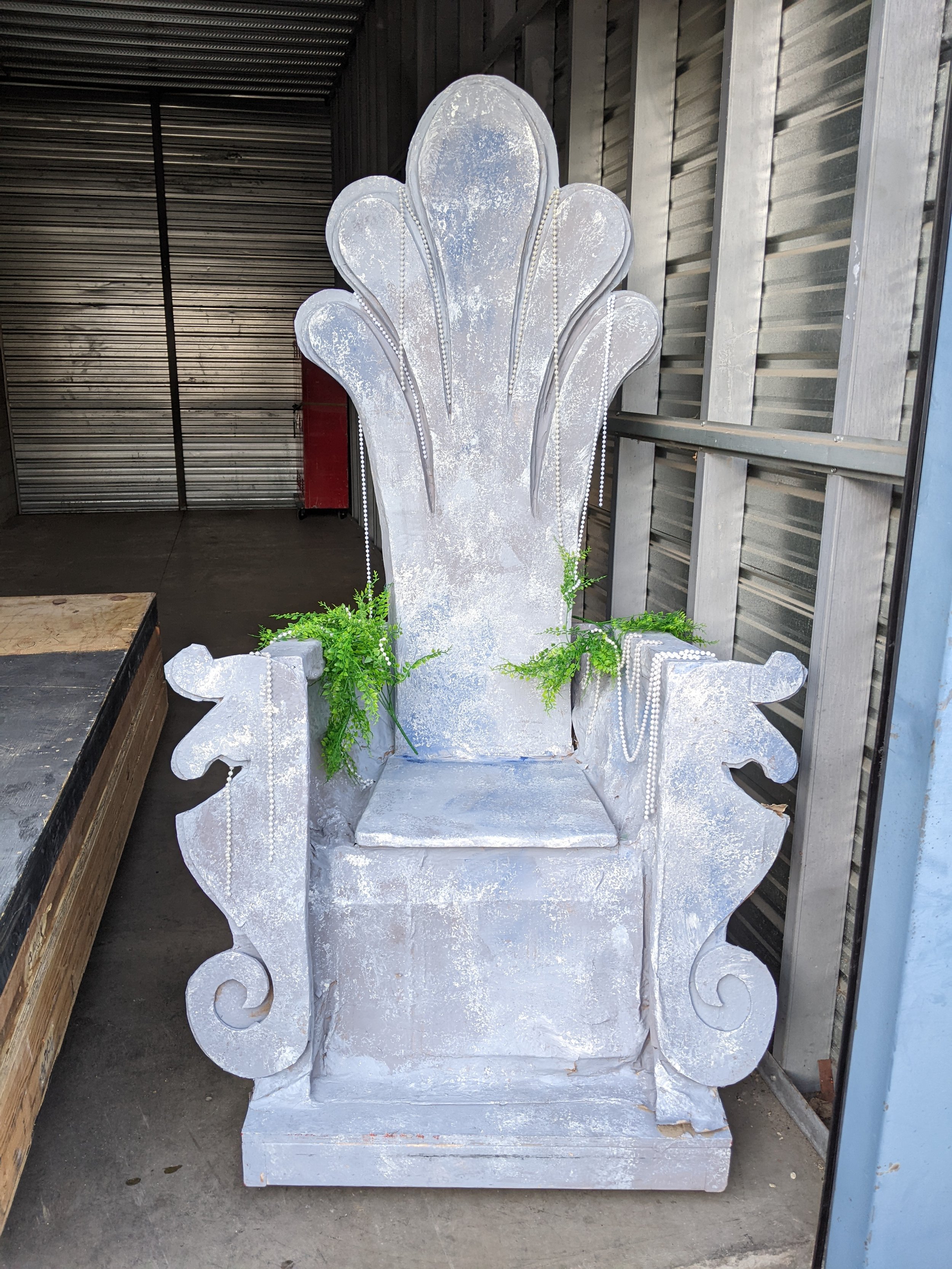 silver blue seashell throne with greenery and pearl accents