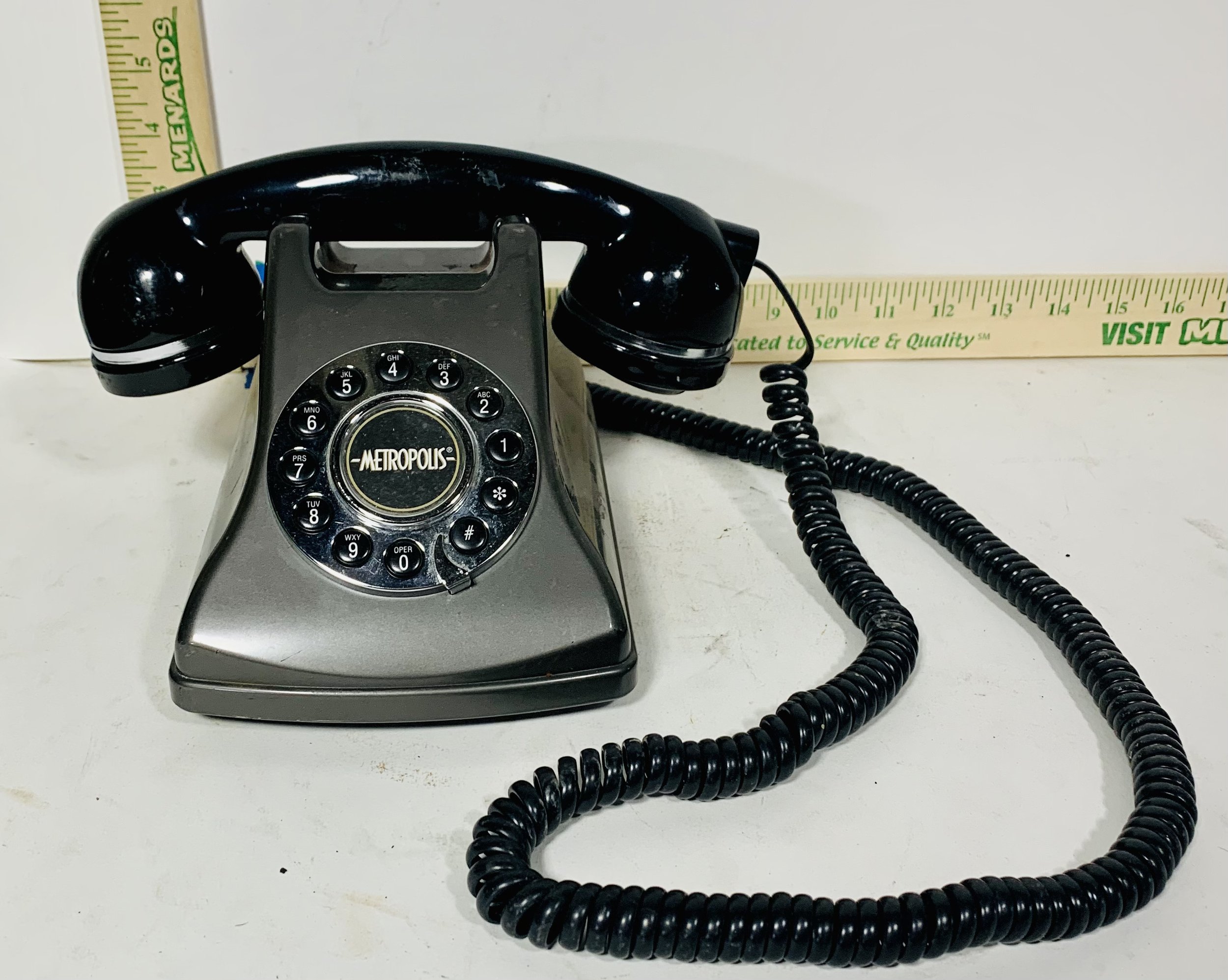 black rotary phone with black cord