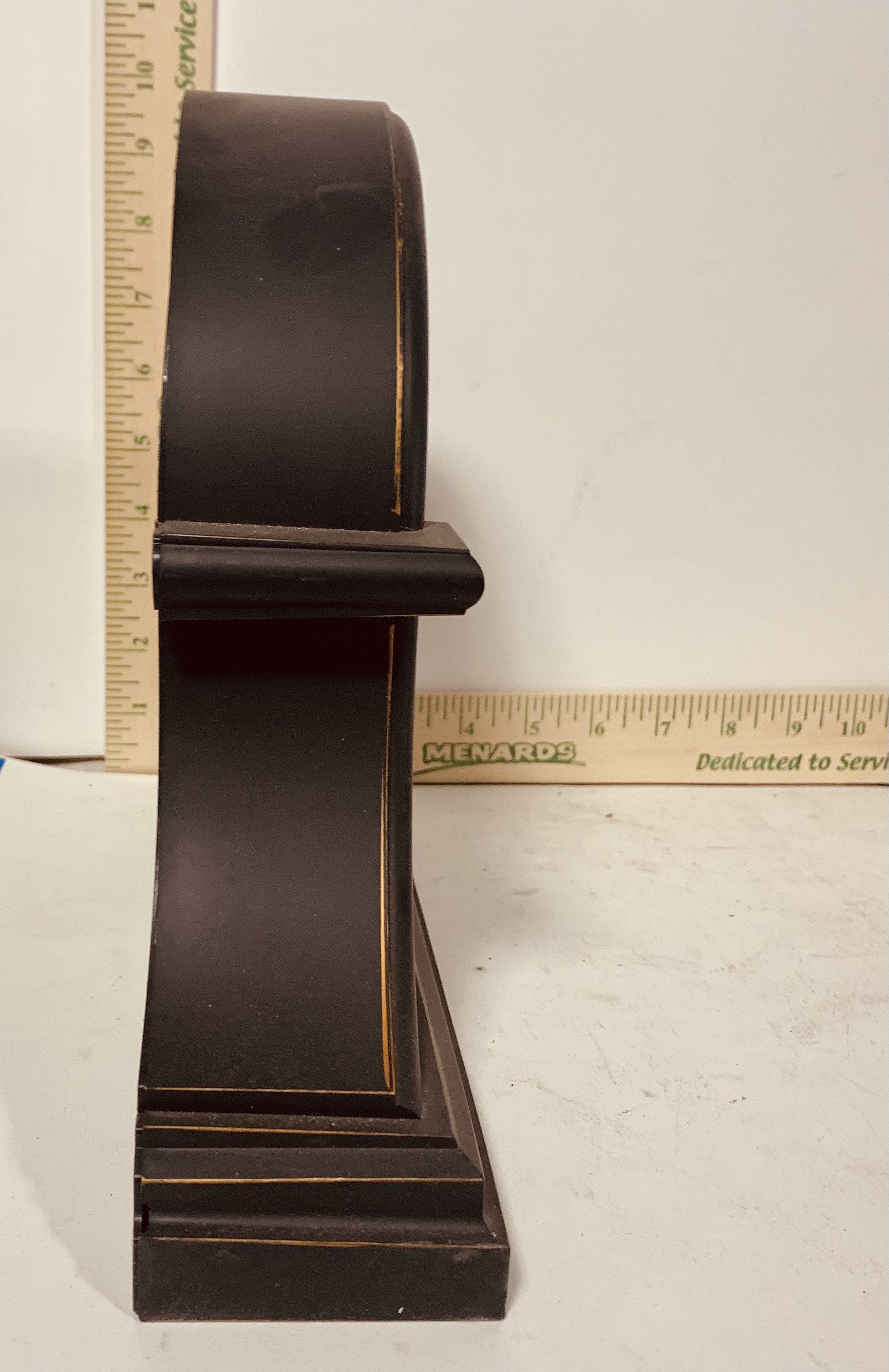 Side view dark wood mantel clock with rulers