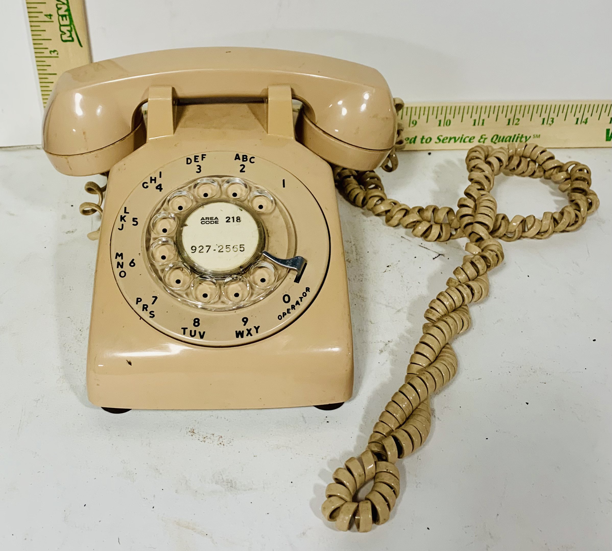 top view beige rotary phone with beige cord