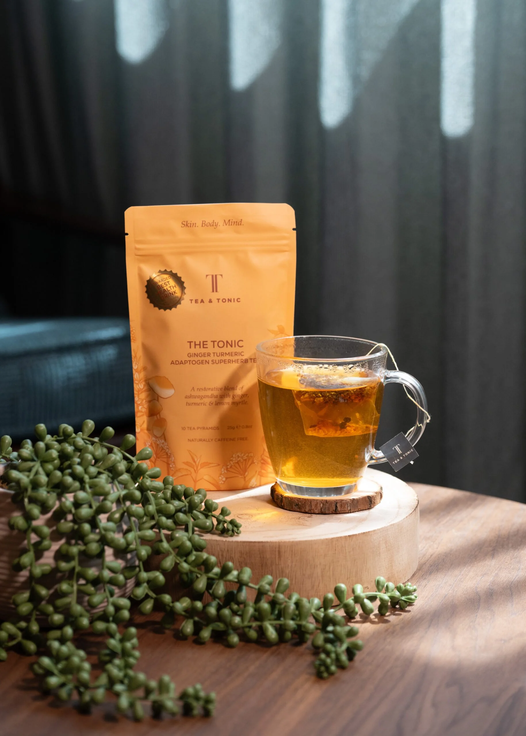A glass mug of Tea & Tonic Ginger Turmeric Adaptogen Superherb Tea at Being Wellness Centre in St Albans, served as a premium herbal refreshment for guests enjoying wellness treatments.