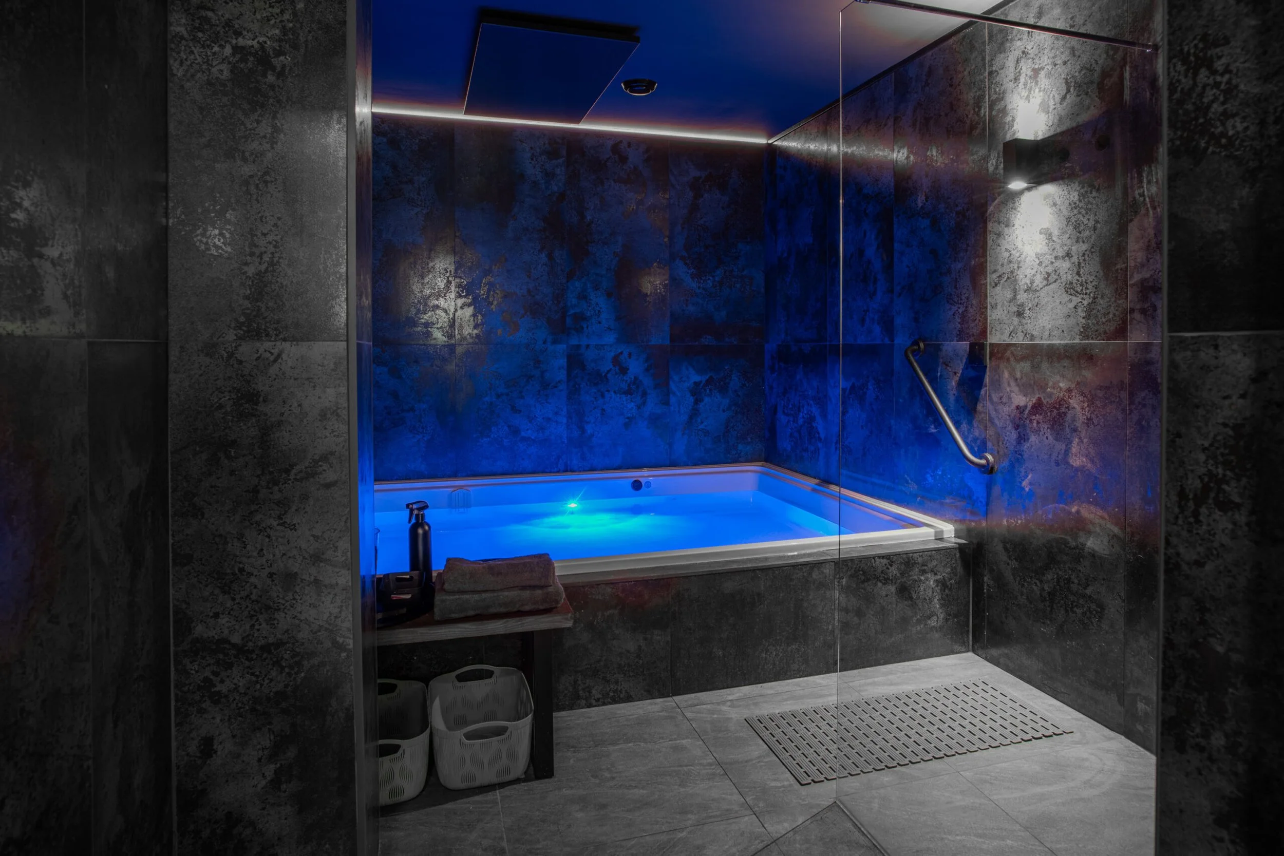Private float therapy room at Being Wellness Centre in St Albans, featuring a contemporary float tank, luxury amenities and a tranquil environment for relaxation and recovery.