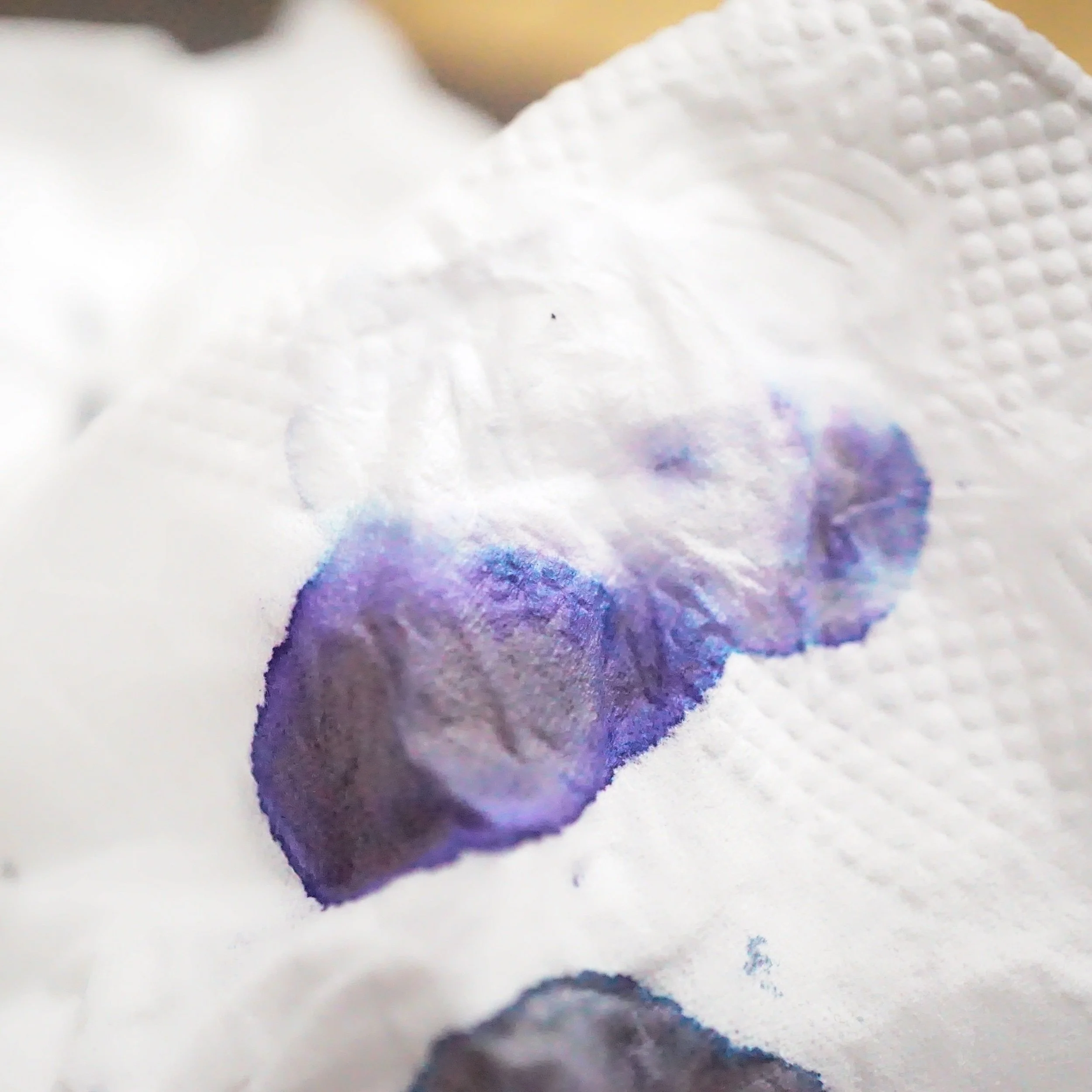 on a piece of tissue paper we can see a bit more of the chromatography, some bright blue, purple and black makes it an interesting color combination up close