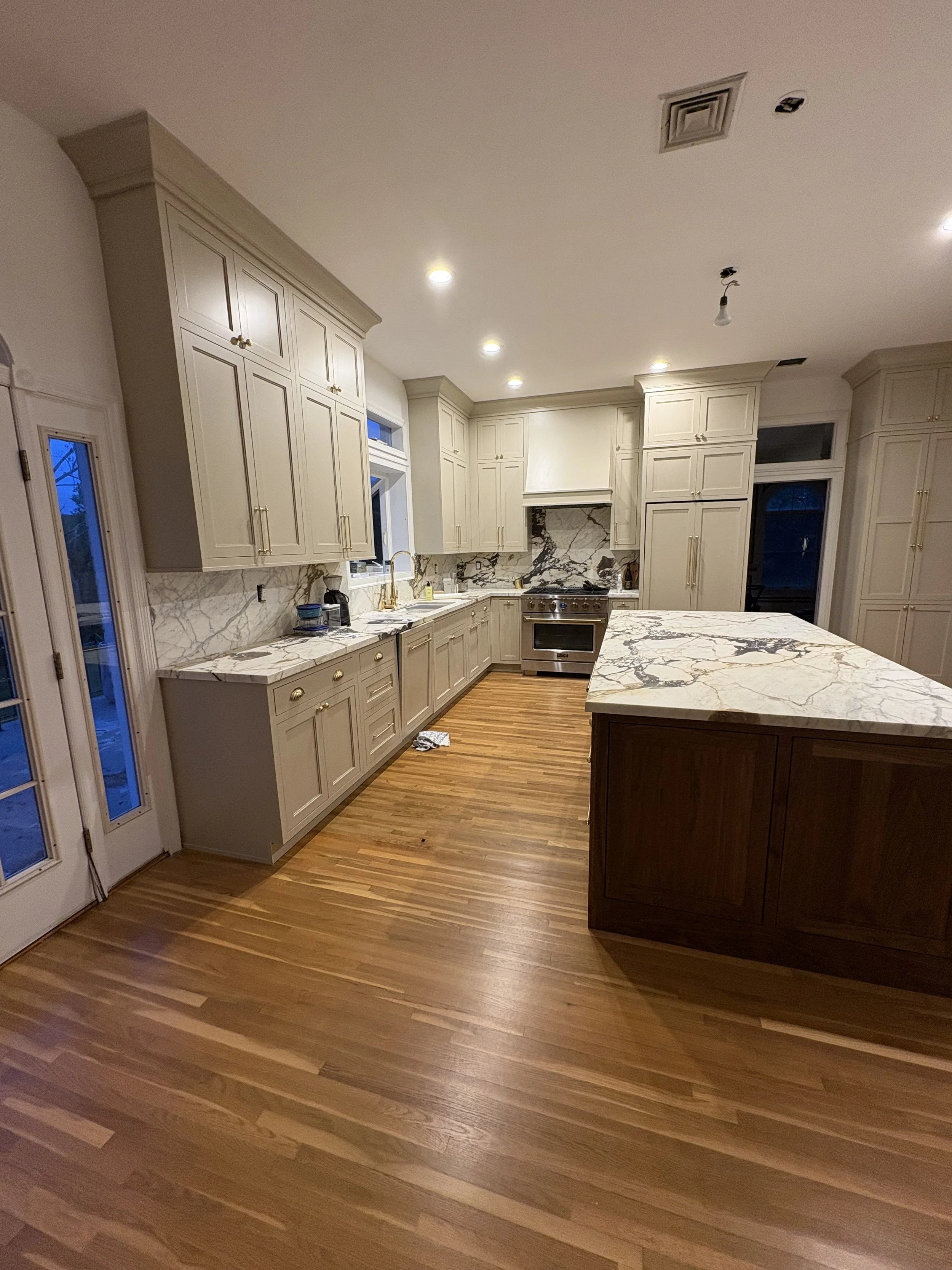 New kitchen installation high toped cabinets inset doors grey with brasss and marble finishings