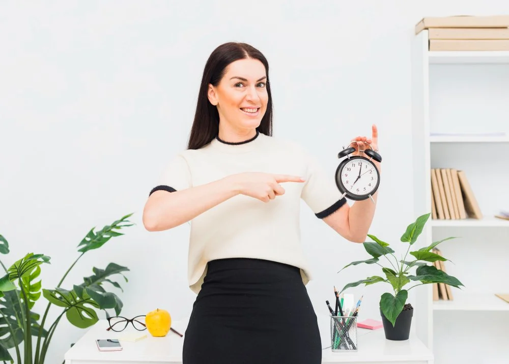 Woman pointing to a clock