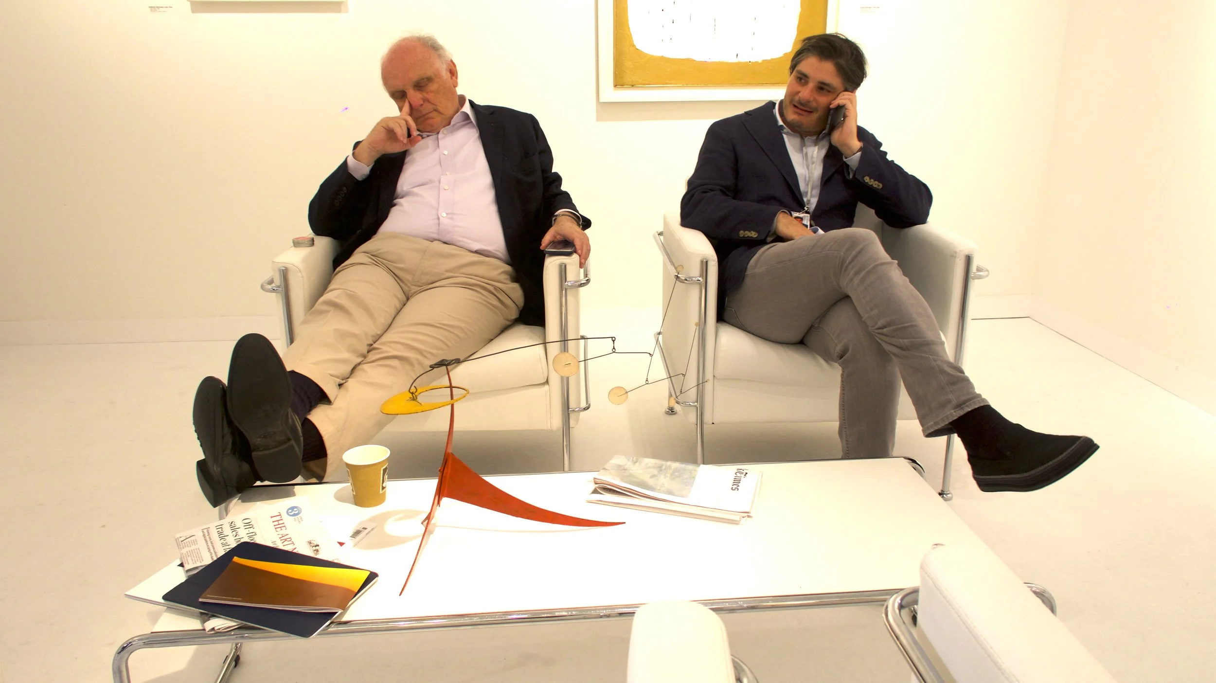 David Nahmad sleeping in Art Basel Miami with Helly Nahmad calling in their Art Booth © Lea Lee ( Art Travel Series ) 