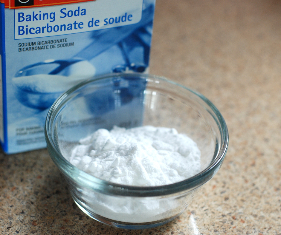Box of baking soda with some poured out into a small bowl