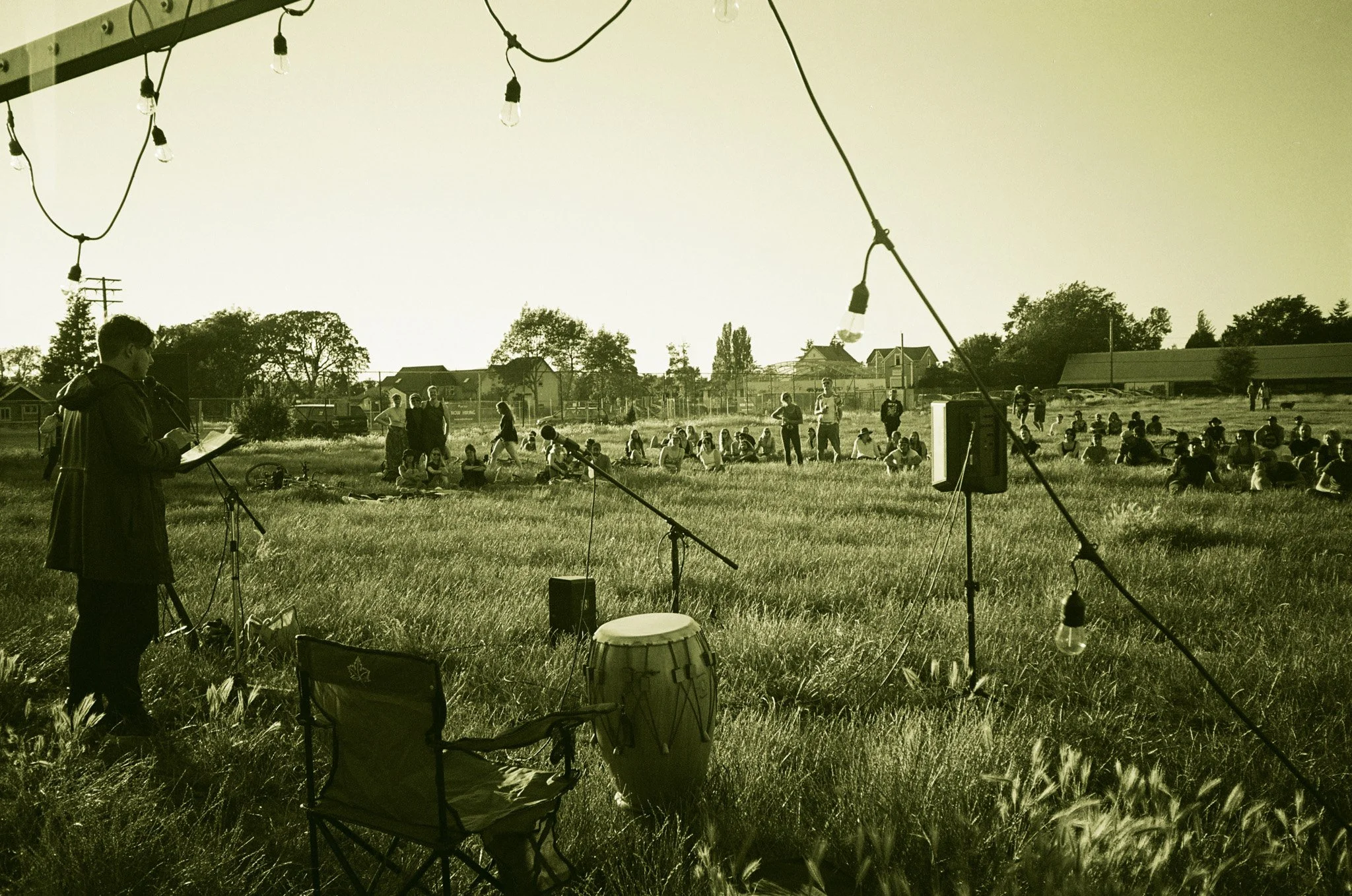 Outdoor event with speaker, microphone, and audience