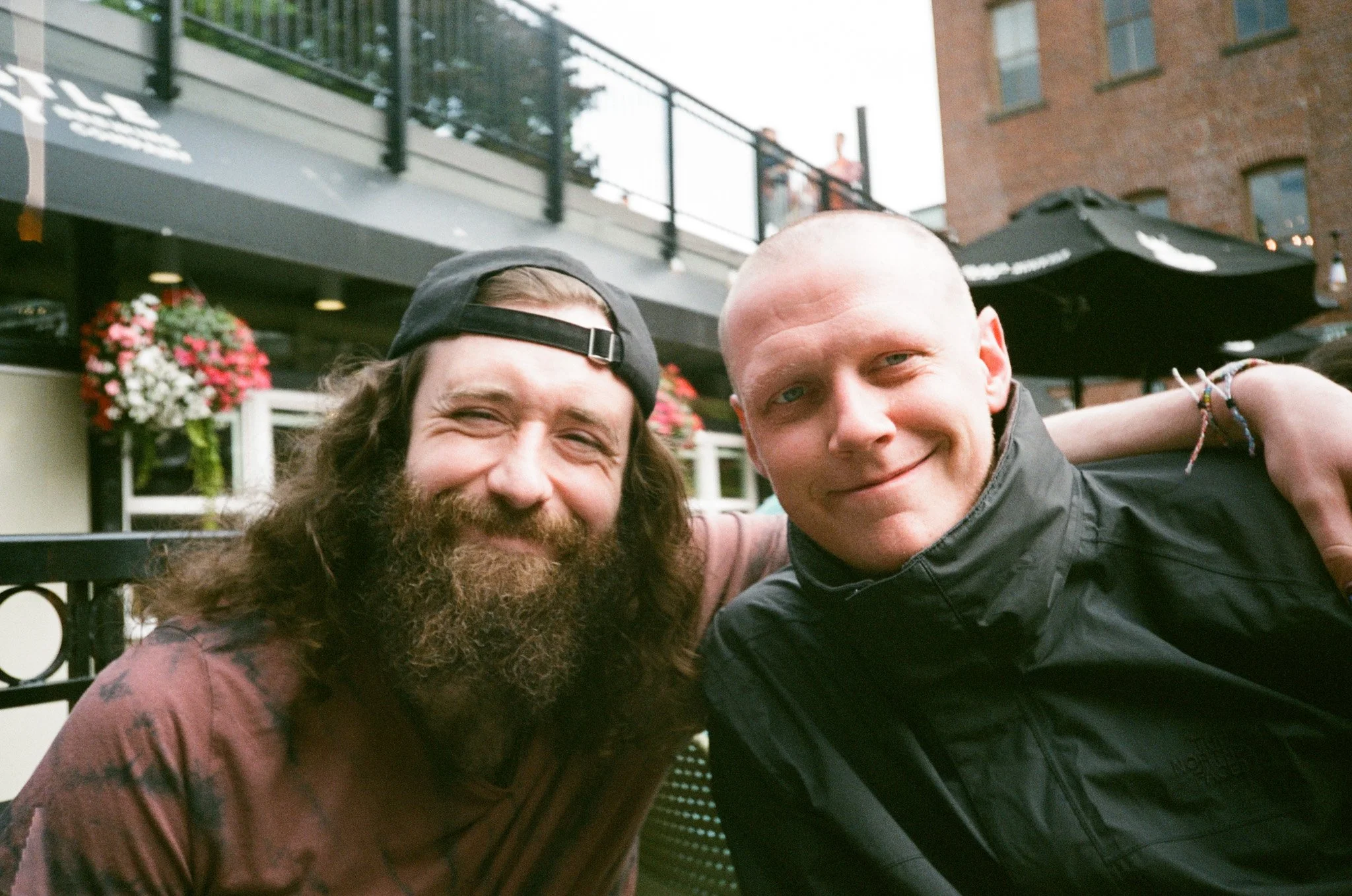 Two friends smiling at an outdoor cafe