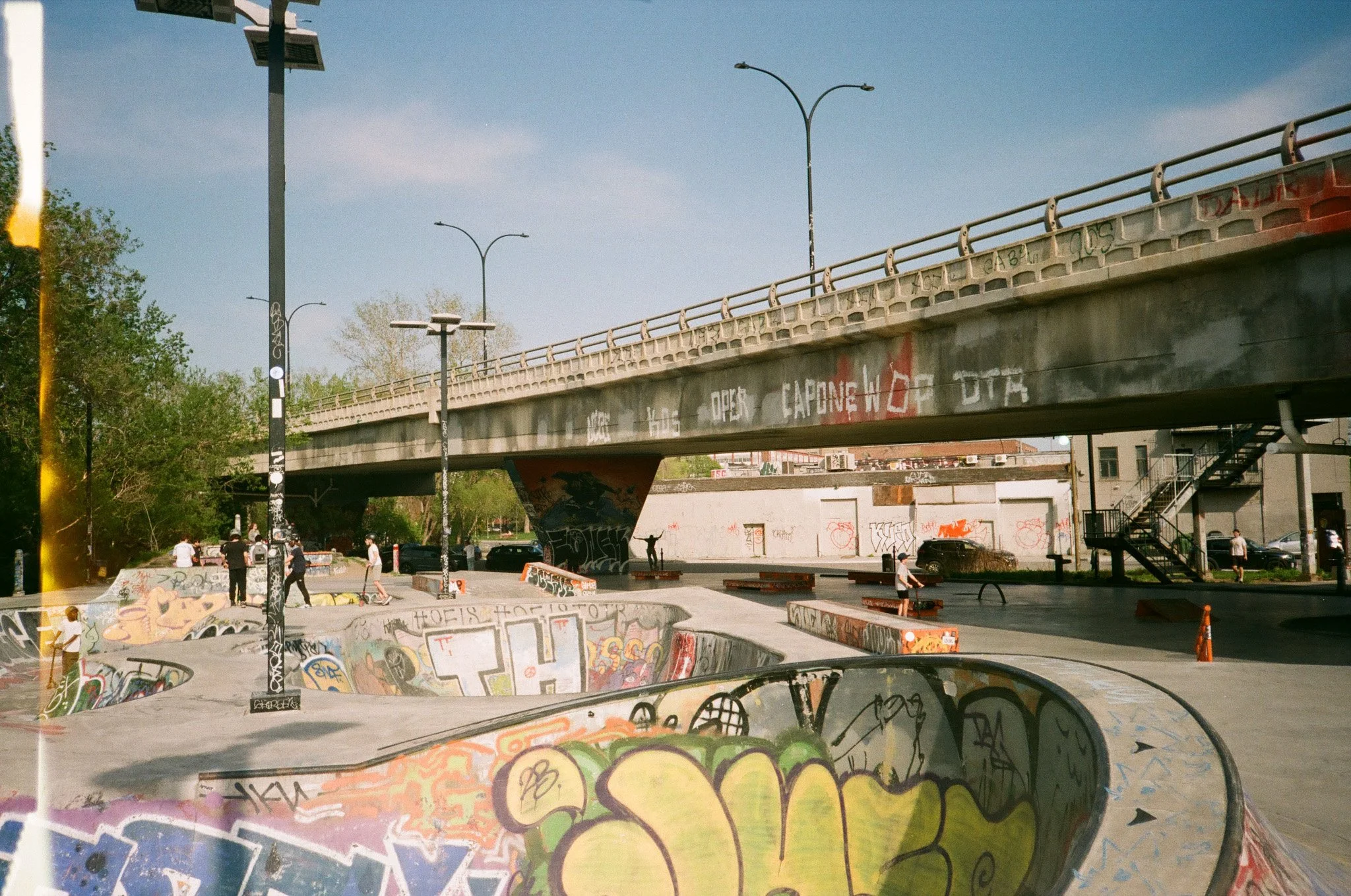 Urban skate park with graffiti under a bridge. Mile End, Montreal.