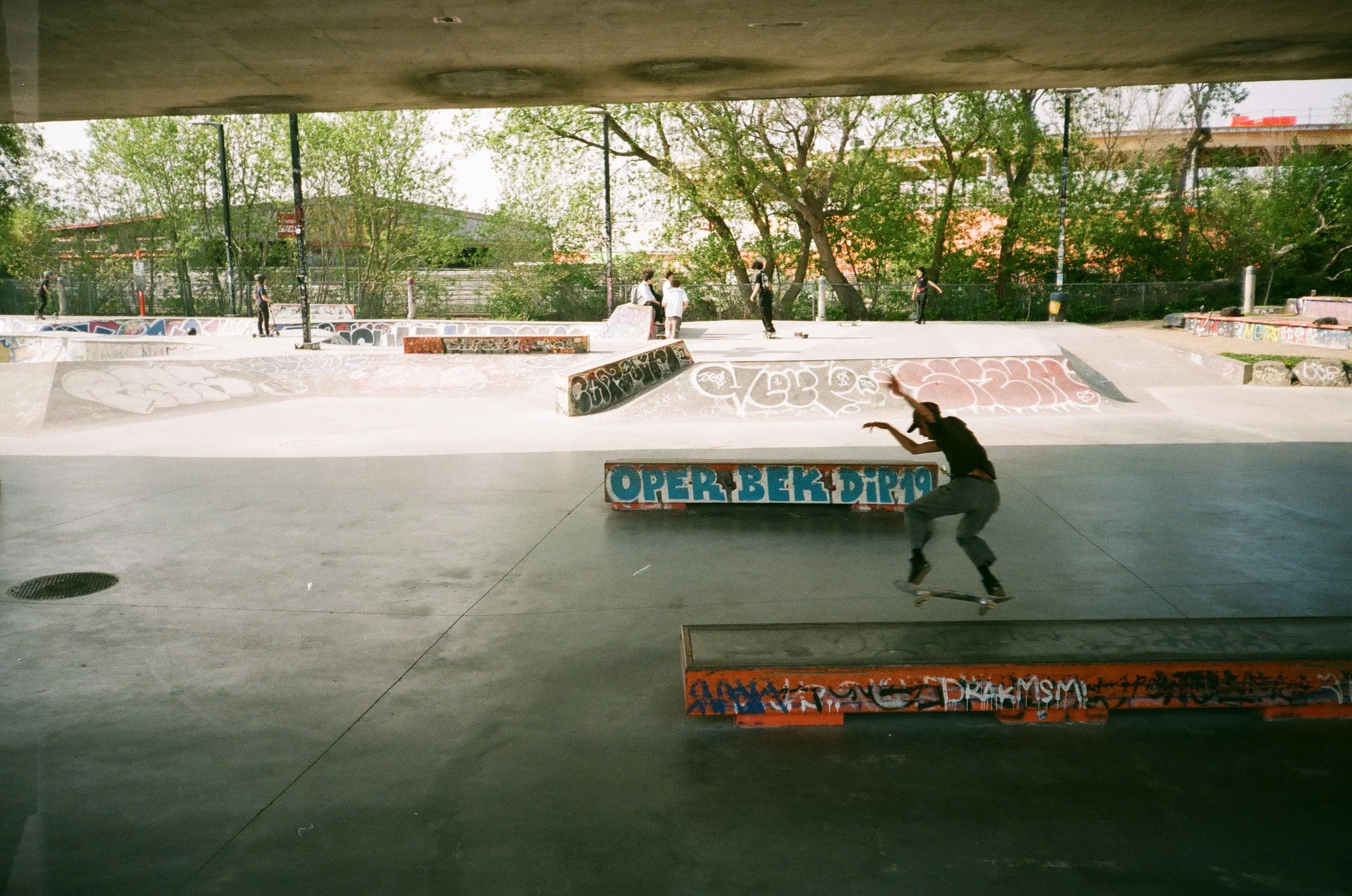 Skateboarder performing trick at graffiti-covered Van Horne skatepark in Montreal